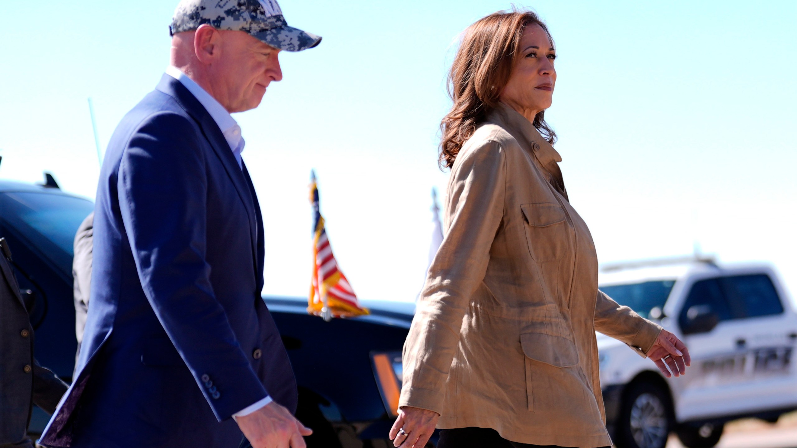 Democratic presidential nominee Vice President Kamala Harris followed by Sen. Mark Kelly, D-Ariz., walks after arriving in Douglas, Ariz., Friday, Sept. 27, 2024. (AP Photo/Carolyn Kaster)