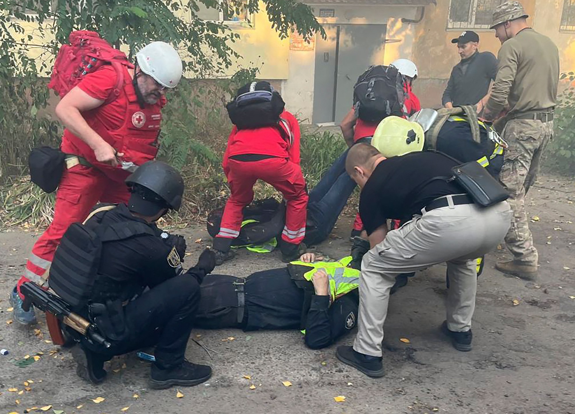 In this photo provided by the Ukrainian Emergency Service, paramedics give first aid to injured Emergency Service workers after Russian attacks on a medical center in the northeastern Ukrainian city of Sumy Saturday, Sept. 28, 2024. (Ukrainian Emergency Service via AP)