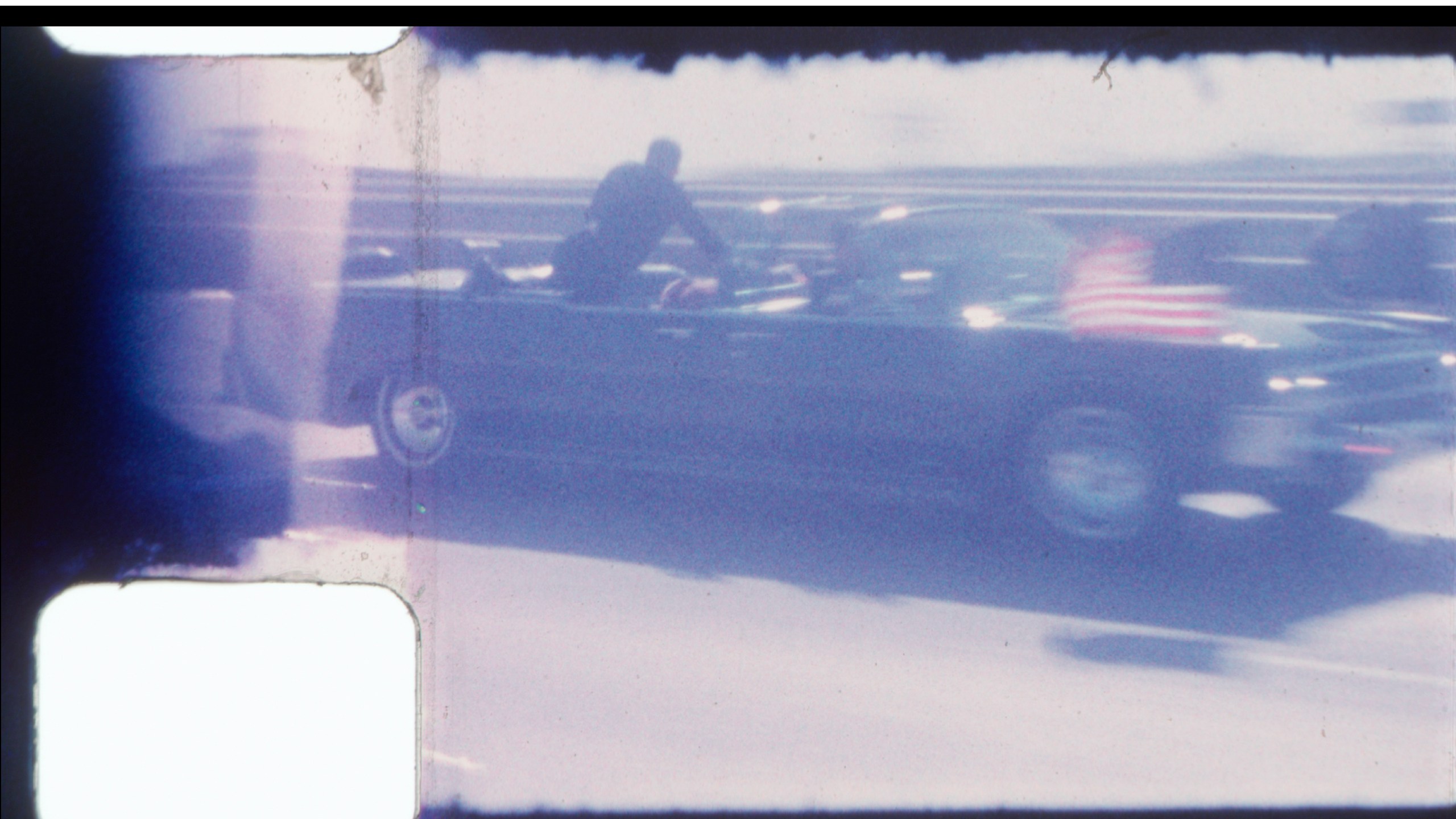 FILE - An undated image released by RR Auction shows home film footage of President John F. Kennedy's motorcade speeding down a Dallas freeway to the hospital after he was fatally wounded on Nov. 22, 1963. (RR Auction via AP, File)