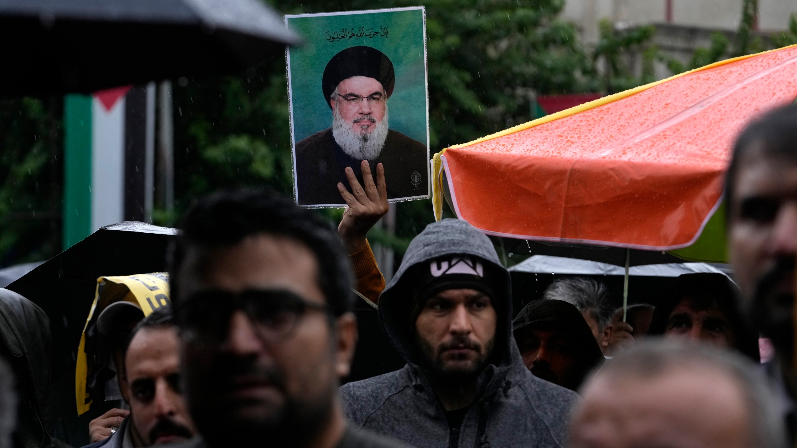 An Iranian demonstrator holds up a poster of the leader of Lebanon's militant Hezbollah group Hassan Nasrallah in a gathering to support Hezbollah at the Felestin (Palestine) Square in downtown Tehran, Iran, Saturday, Sept. 28, 2024. (AP Photo/Vahid Salemi)