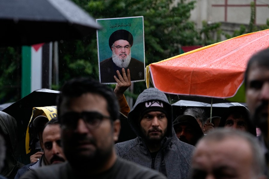 An Iranian demonstrator holds up a poster of the leader of Lebanon's militant Hezbollah group Hassan Nasrallah in a gathering to support Hezbollah at the Felestin (Palestine) Square in downtown Tehran, Iran, Saturday, Sept. 28, 2024. (AP Photo/Vahid Salemi)