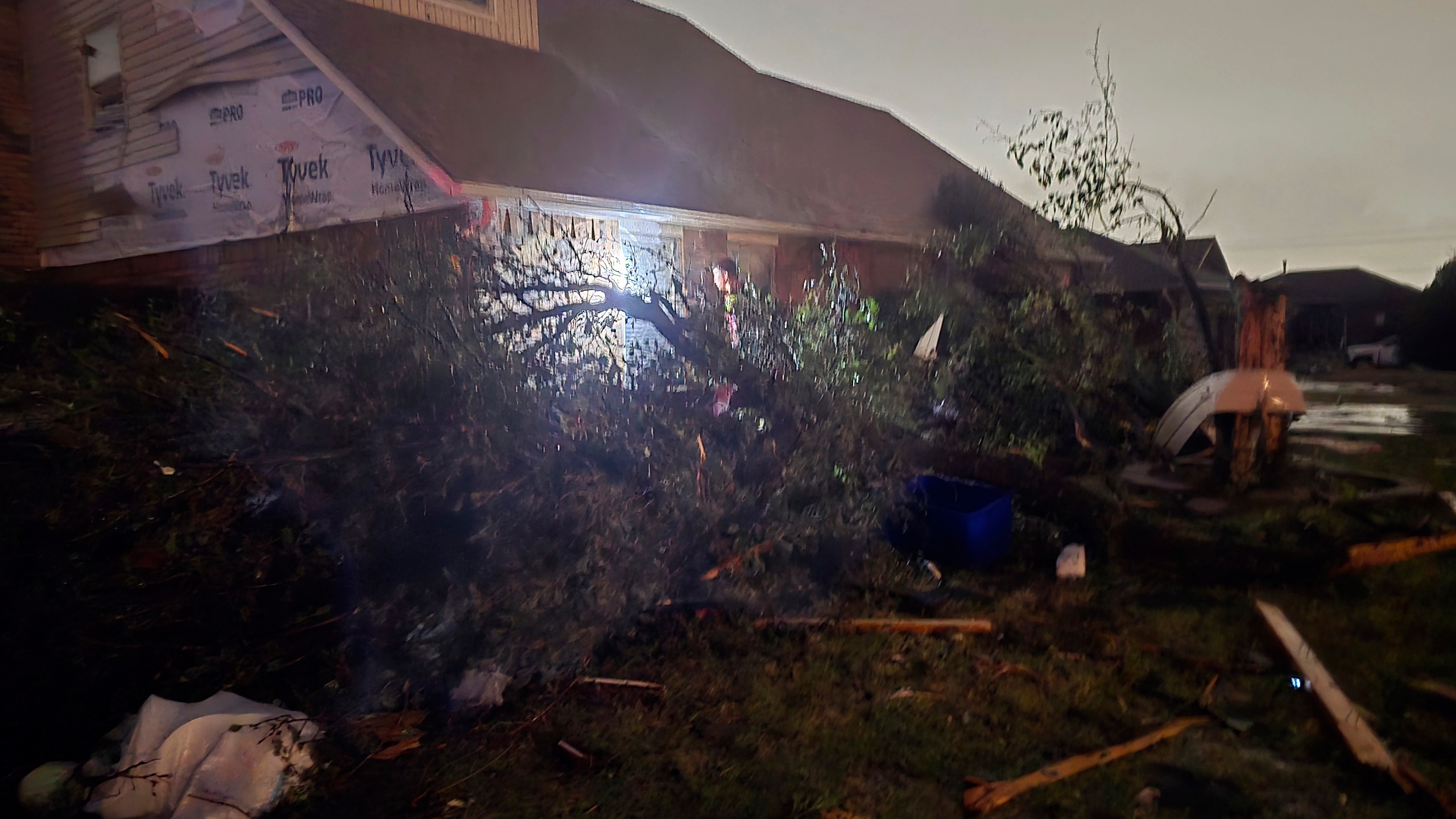 This image provided by Sean Taylor shows a person entering a damaged home after a tornado hit the area in Midwest City, Okla,, Sunday, Nov. 3, 2024. (Sean Taylor via AP)