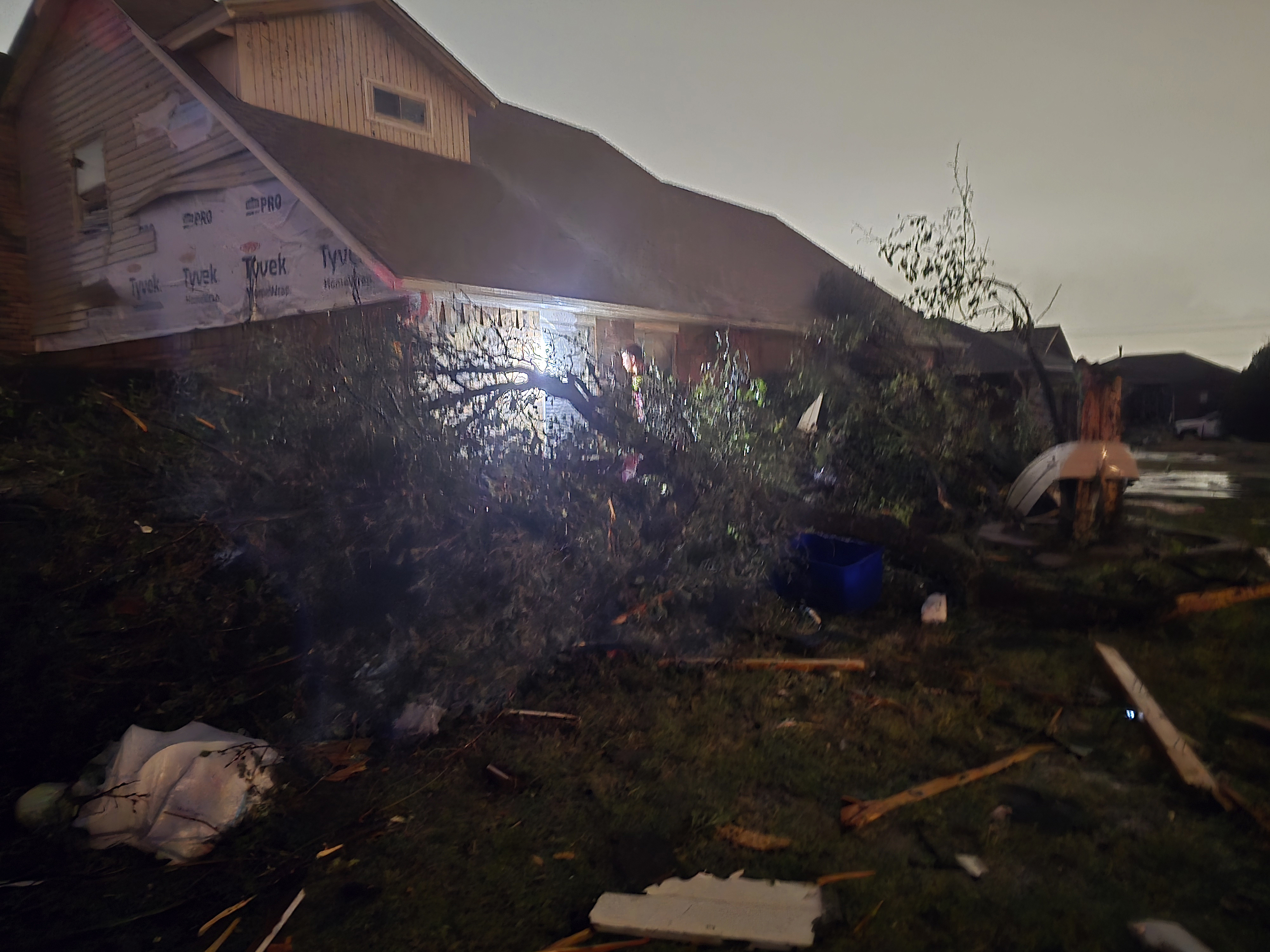 This image provided by Sean Taylor shows a person entering a damaged home after a tornado hit the area in Midwest City, Okla,, Sunday, Nov. 3, 2024. (Sean Taylor via AP)