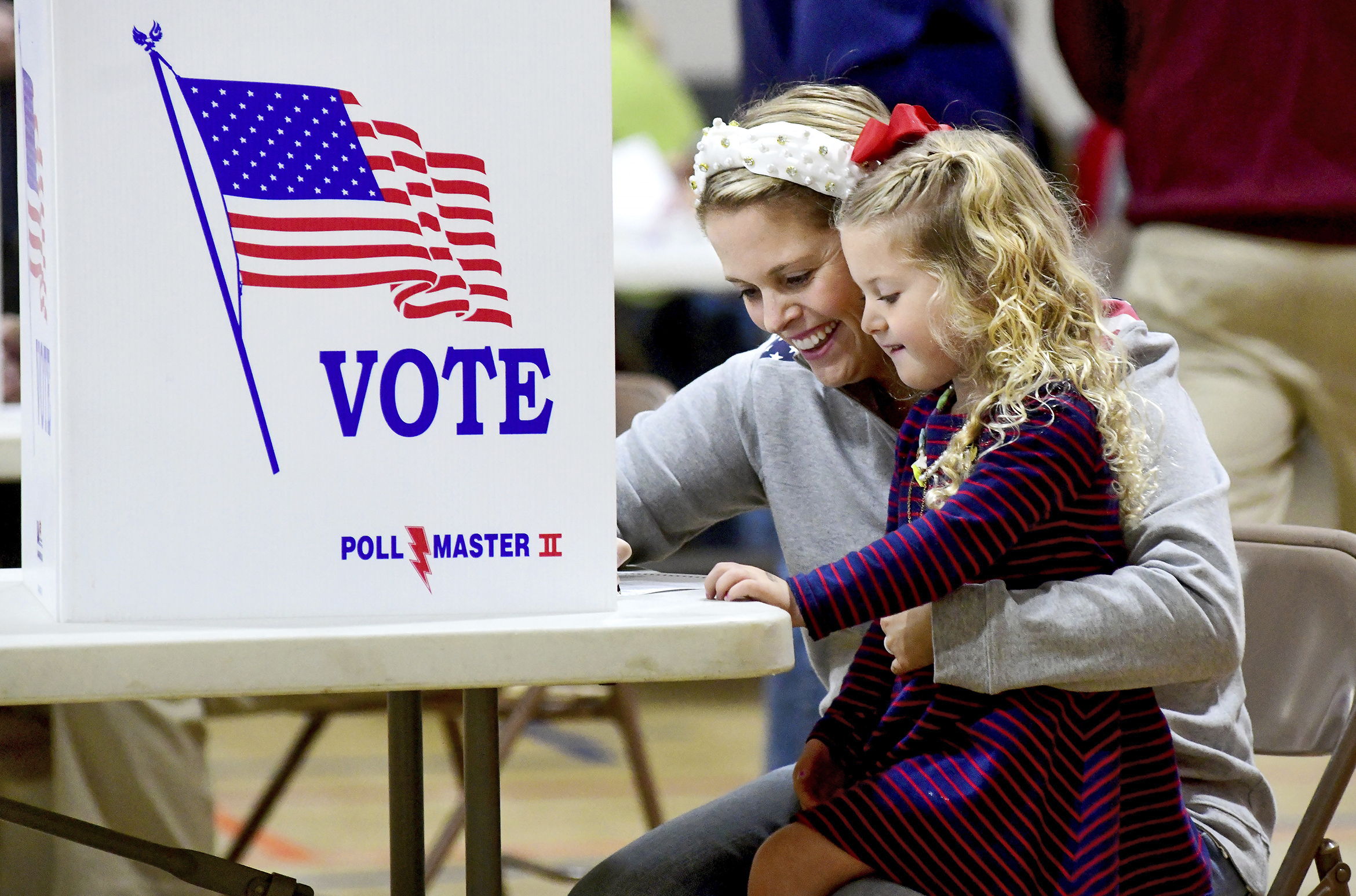 Kate Aurandt-Gribbler holds her daughter, Olivia Gribbler, 3, as she votes at the Westmont Borough No. 1 polling place at Westmont Grove in Johnstown, Pa., in Cambria County, on Tuesday, Nov. 5, 2024. (Thomas Slusser/The Tribune-Democrat via AP)