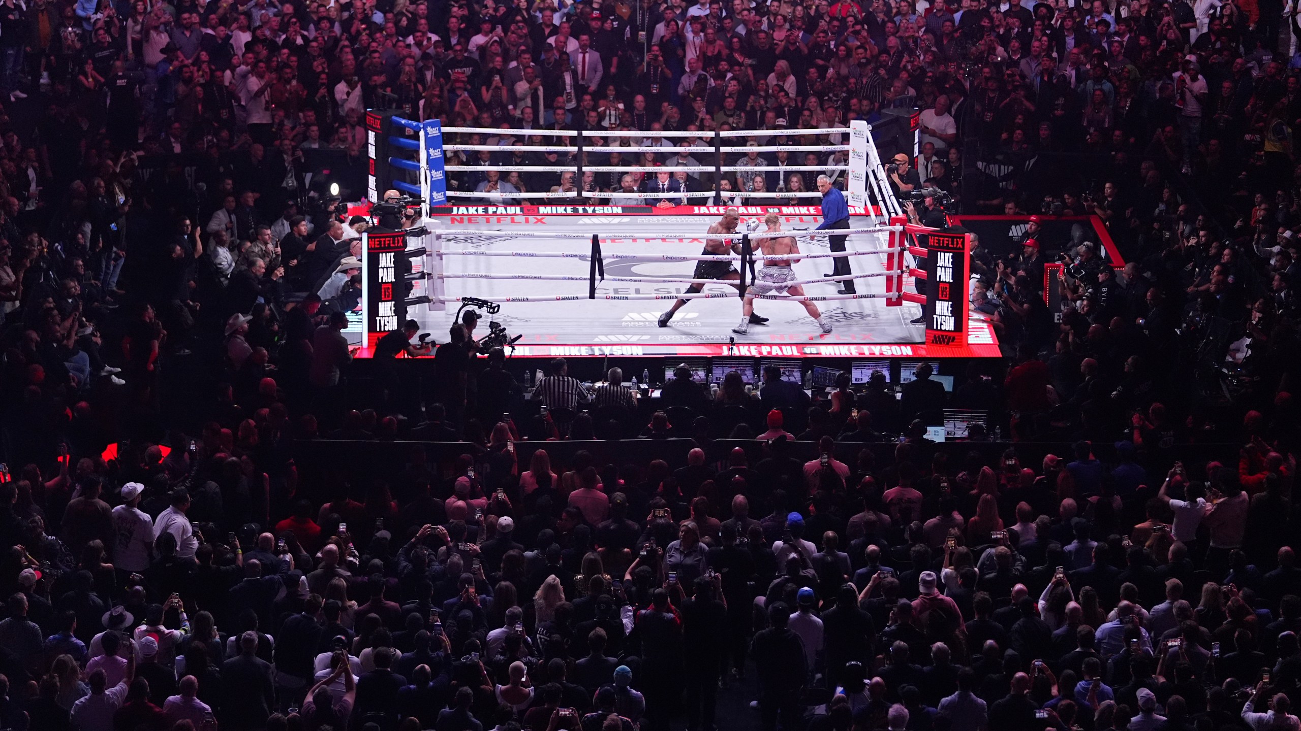 Mike Tyson, left, fights Jake Paul during their heavyweight boxing match, Friday, Nov. 15, 2024, in Arlington, Texas. (AP Photo/Julio Cortez)