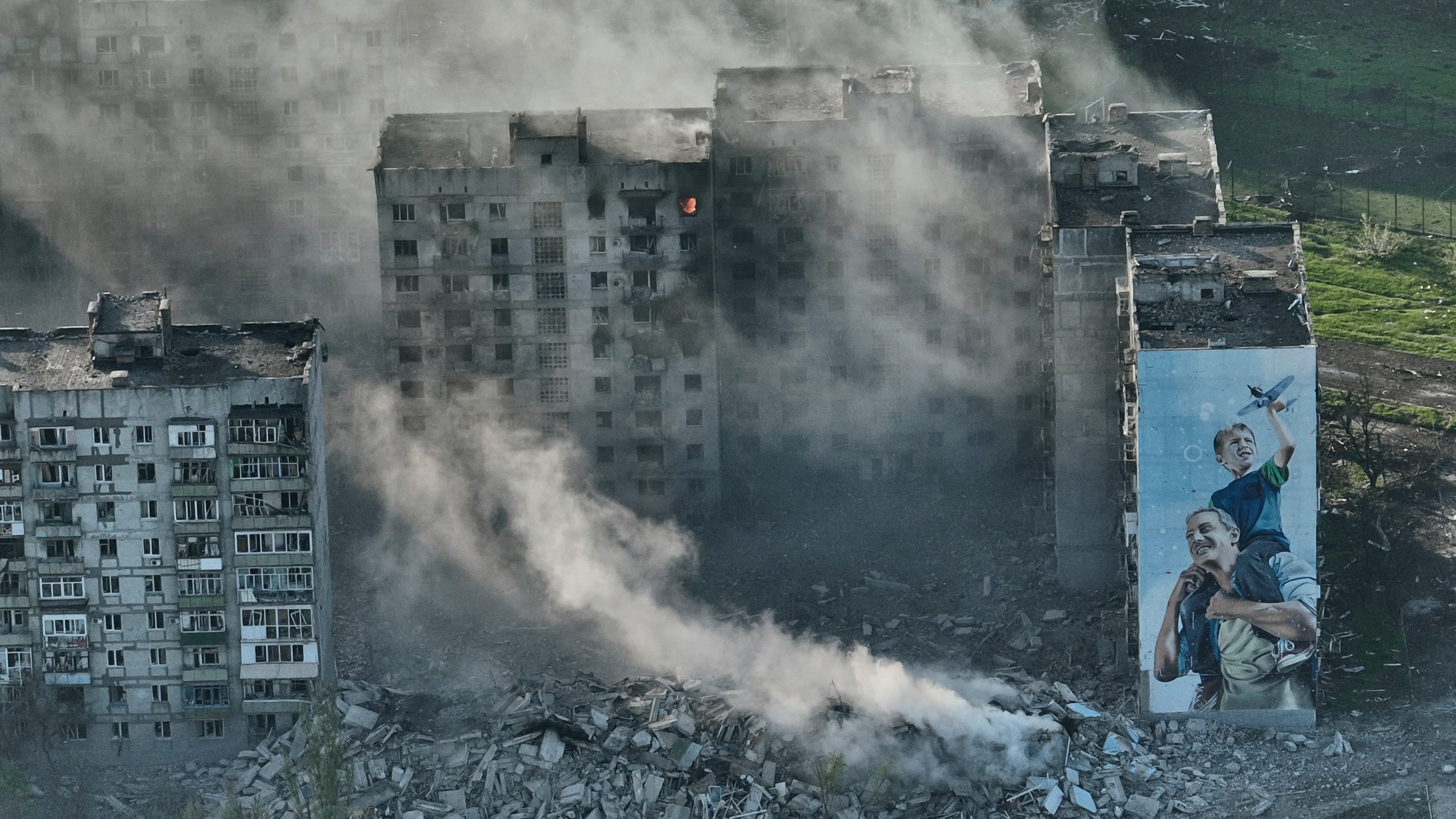 FILE - Smoke rises from a building in Bakhmut, the site of the heaviest battles with the Russian troops in the Donetsk region, Ukraine, Wednesday, April 26, 2023. (AP Photo/Libkos, File)