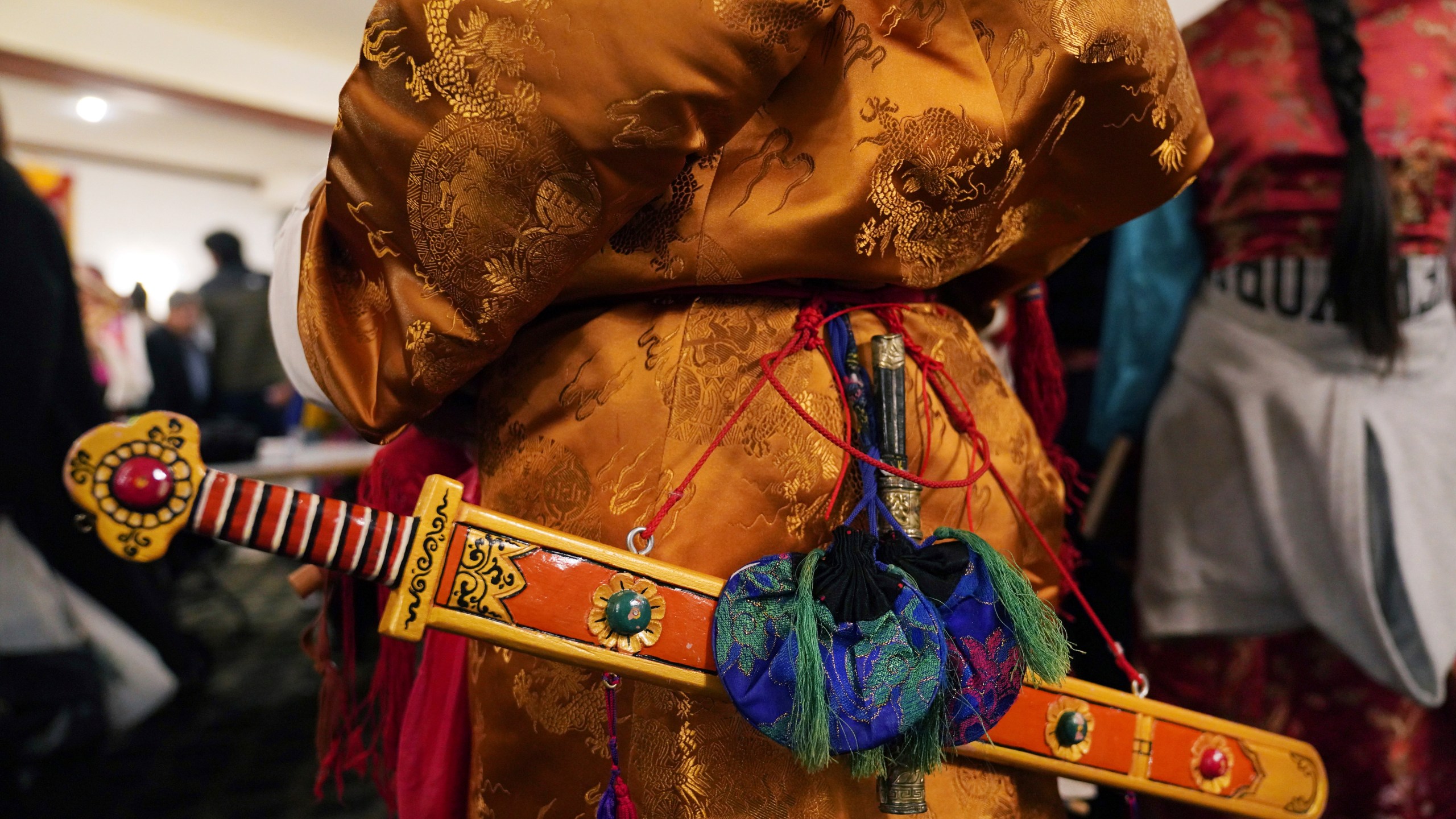 Elders dress in traditional clothing to perform a ceremonial Tibetan dance to welcome U.S.-born Buddhist lama, Jalue Dorje, to his 18th birthday and enthronement ceremony in Isanti, Minn., on Saturday, Nov. 9, 2024. (AP Photo/Jessie Wardarski)