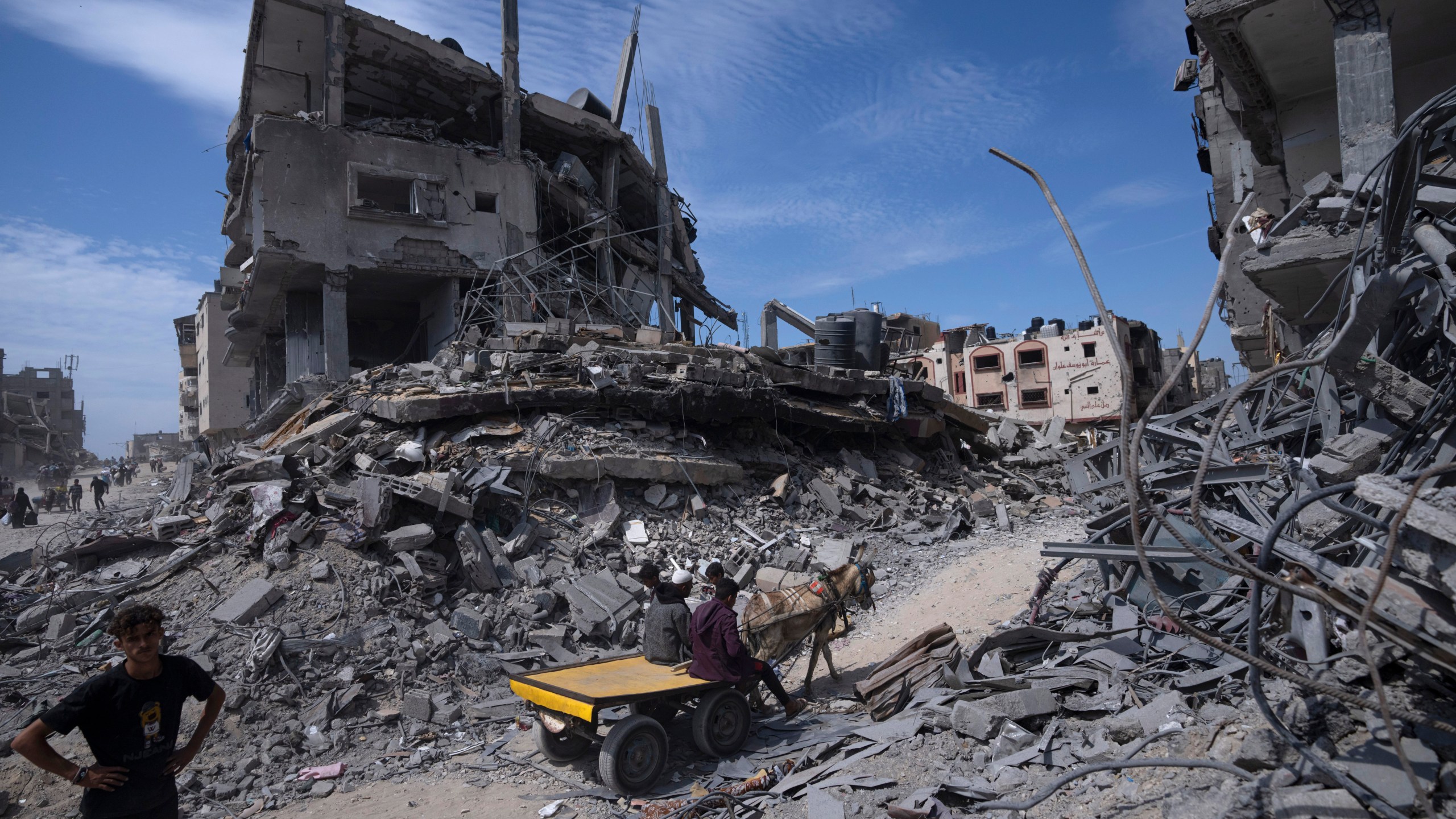 FILE - Palestinians salvage what they can from the destruction left by Israeli troops in Khan Younis, southern Gaza Strip, on April 8, 2024. (AP Photo/Fatima Shbair, File)