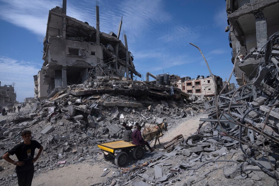 FILE - Palestinians salvage what they can from the destruction left by Israeli troops in Khan Younis, southern Gaza Strip, on April 8, 2024. (AP Photo/Fatima Shbair, File)