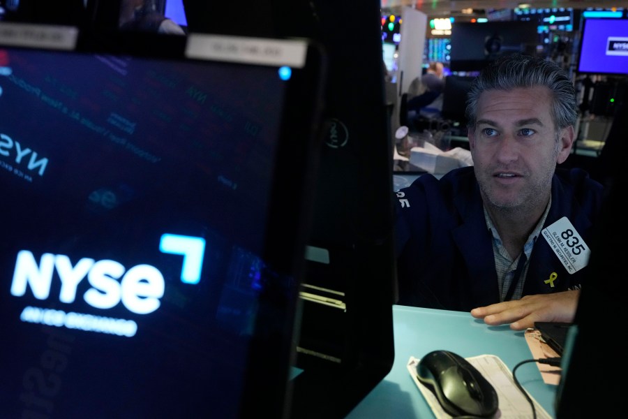 Trader Glenn Kessler works on the floor of the New York Stock Exchange, Wednesday, Dec. 18, 2024. (AP Photo/Richard Drew)