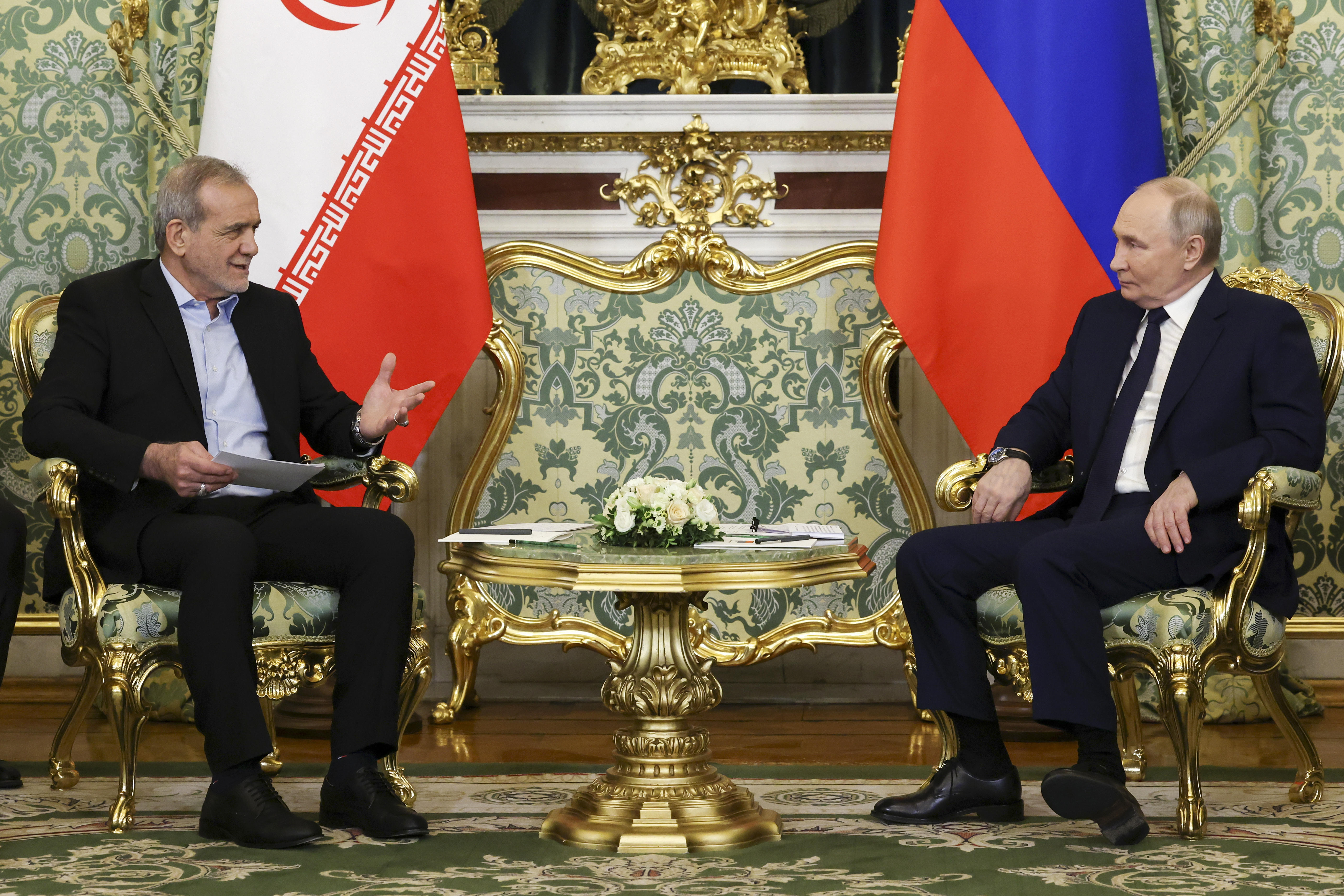 Russian President Vladimir Putin, right, and Iranian President Masoud Pezeshkian talk to each other during their meeting at the Kremlin in Moscow, Russia, Friday, Jan. 17, 2025. (Vyacheslav Prokofyev, Sputnik, Kremlin Pool Photo via AP)