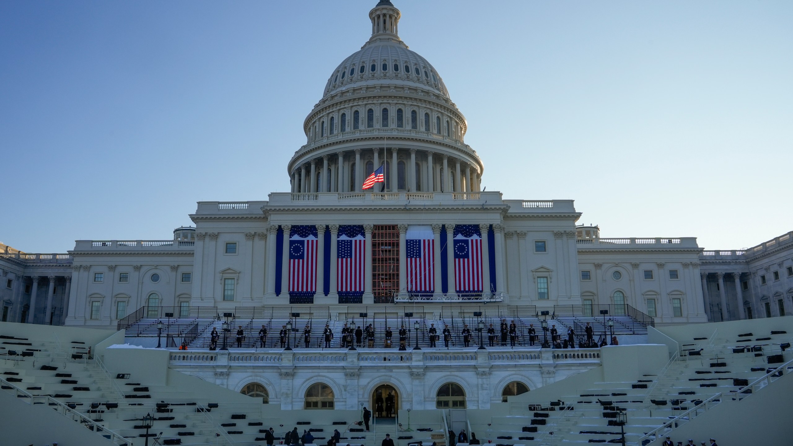 People take their places as a rehearsal begins on the West Front of U.S. Capitol ahead of President-elect Donald Trump's upcoming inauguration, Sunday, Jan. 12, 2025, in Washington. (AP Photo/Jon Elswick)