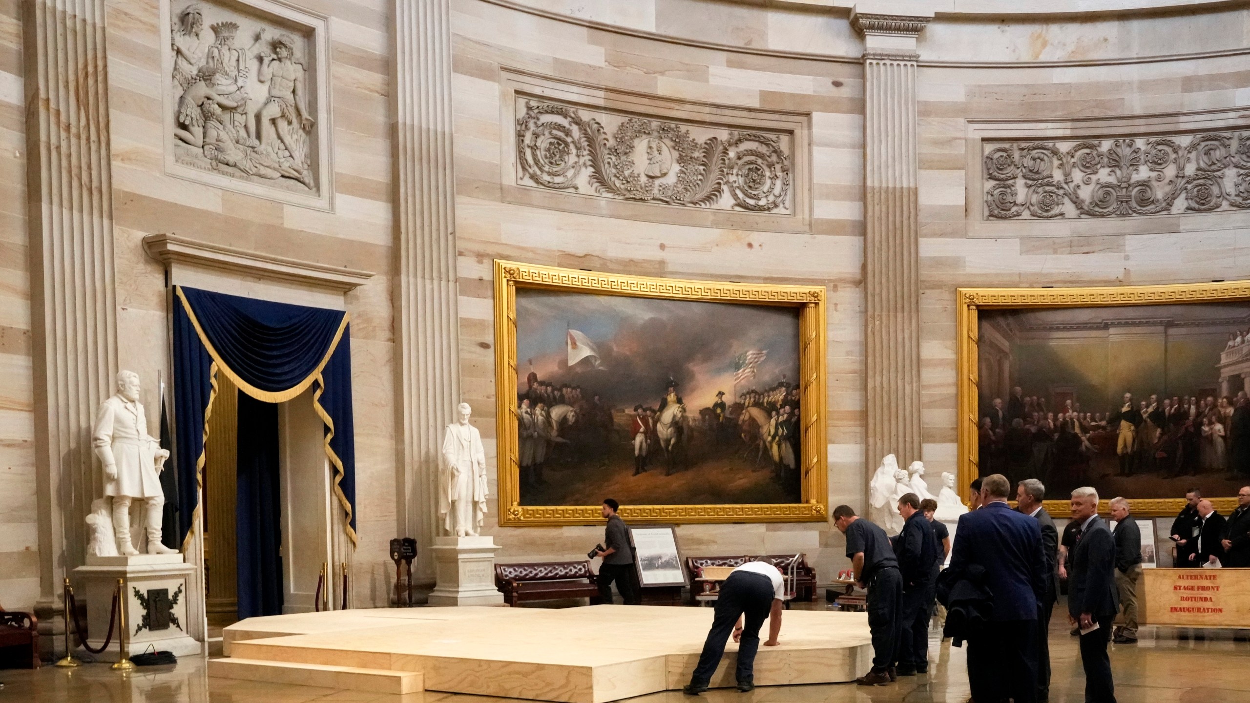 Workers build a stage in the U.S. Capitol Rotunda in Washington Friday, Jan. 17, 2025, for the 60th Presidential Inauguration which was moved indoors because of cold temperatures expected on Jan 20. (AP Photo/Morry Gash)