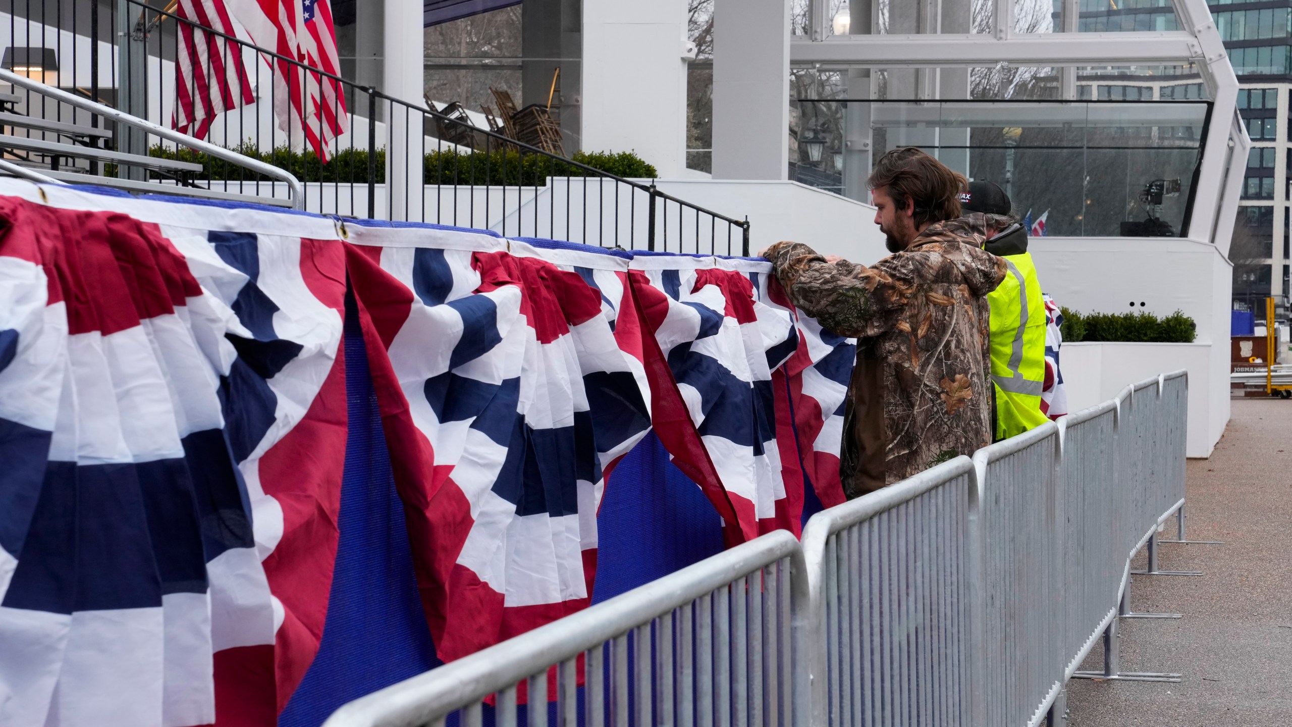 Work continues near the presidential reviewing stand on Pennsylvania Avenue outside the White House, Friday, Jan. 17, 2025, in Washington, ahead of President-elect Donald Trump's inauguration. (AP Photo/Jon Elswick)