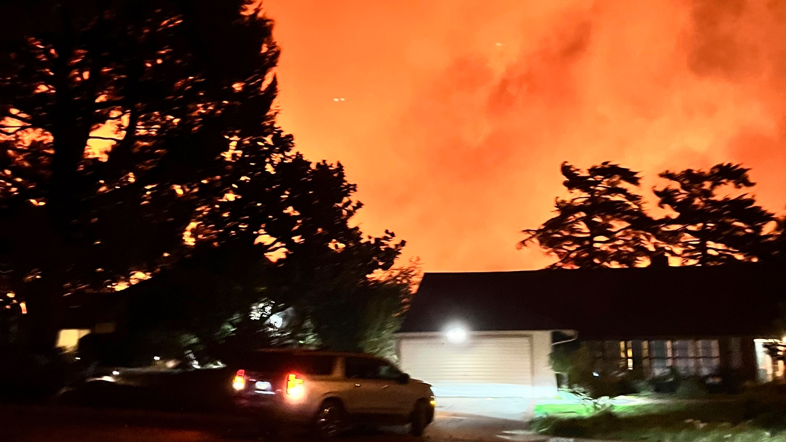 In this photo provided by Pasadena, Calif., resident Matt Logelin, flames burn arond transmission towers owned by Southern California Edison in Eaton Canyon in the early evening of Tuesday, Jan. 7, 2025. (Matt Logelin via AP)