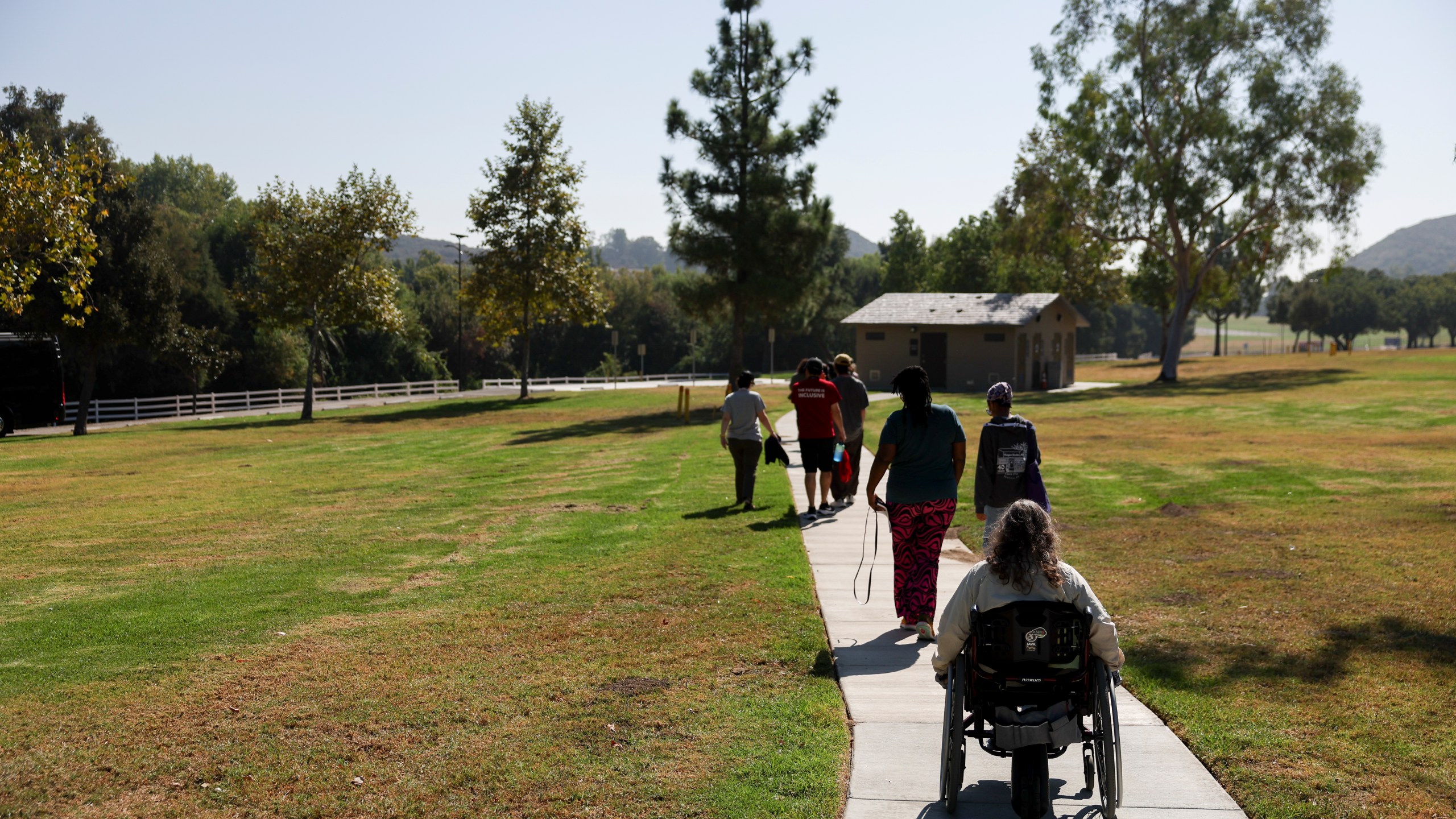 Attendees walk to board a tour bus during an accessible field trip to the San Andreas Fault organized by the International Association of Geoscience Diversity Thursday, Sept. 26, 2024, in San Bernadino, Calif. (AP Photo/Ryan Sun)