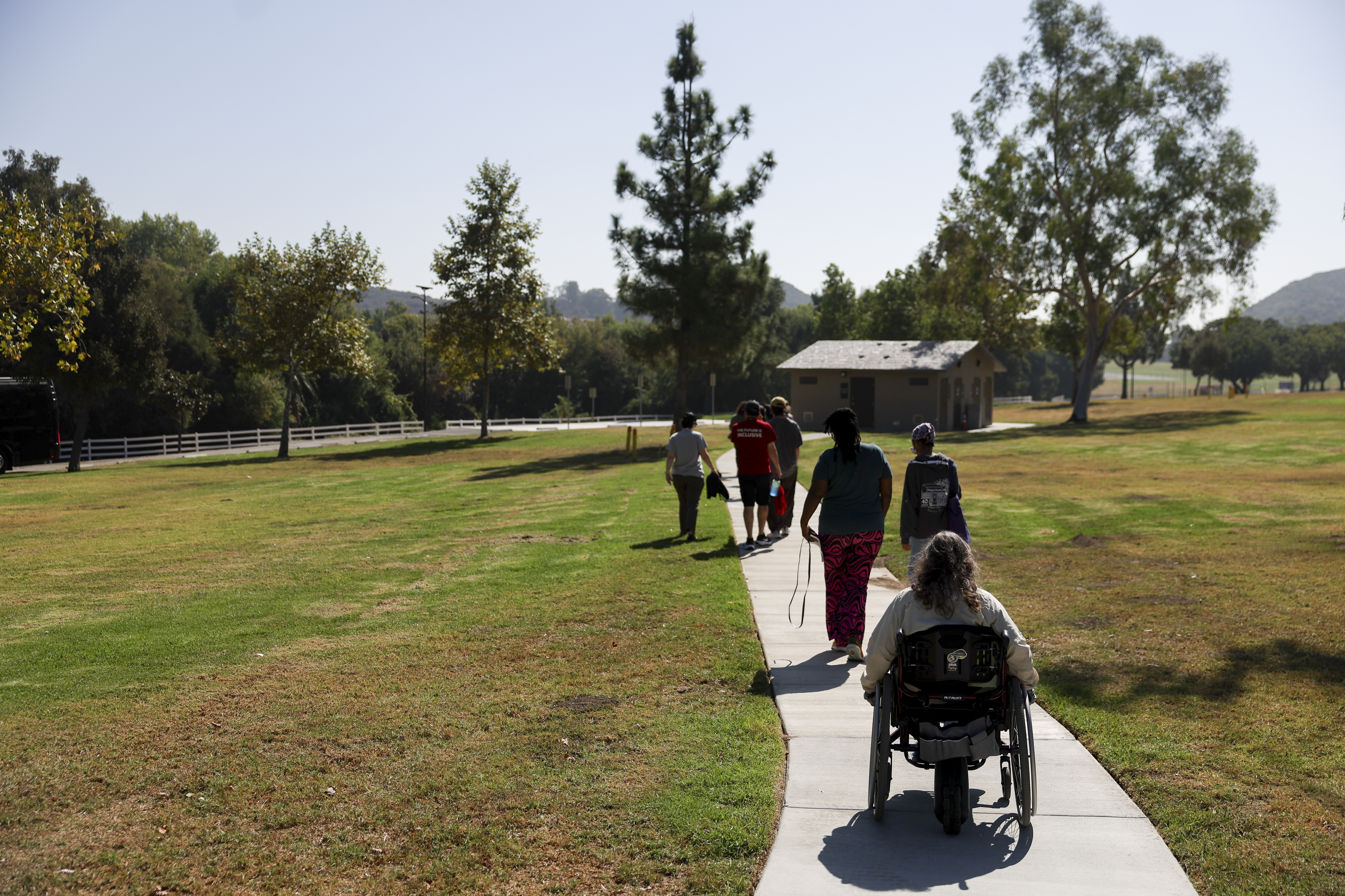 Attendees walk to board a tour bus during an accessible field trip to the San Andreas Fault organized by the International Association of Geoscience Diversity Thursday, Sept. 26, 2024, in San Bernadino, Calif. (AP Photo/Ryan Sun)