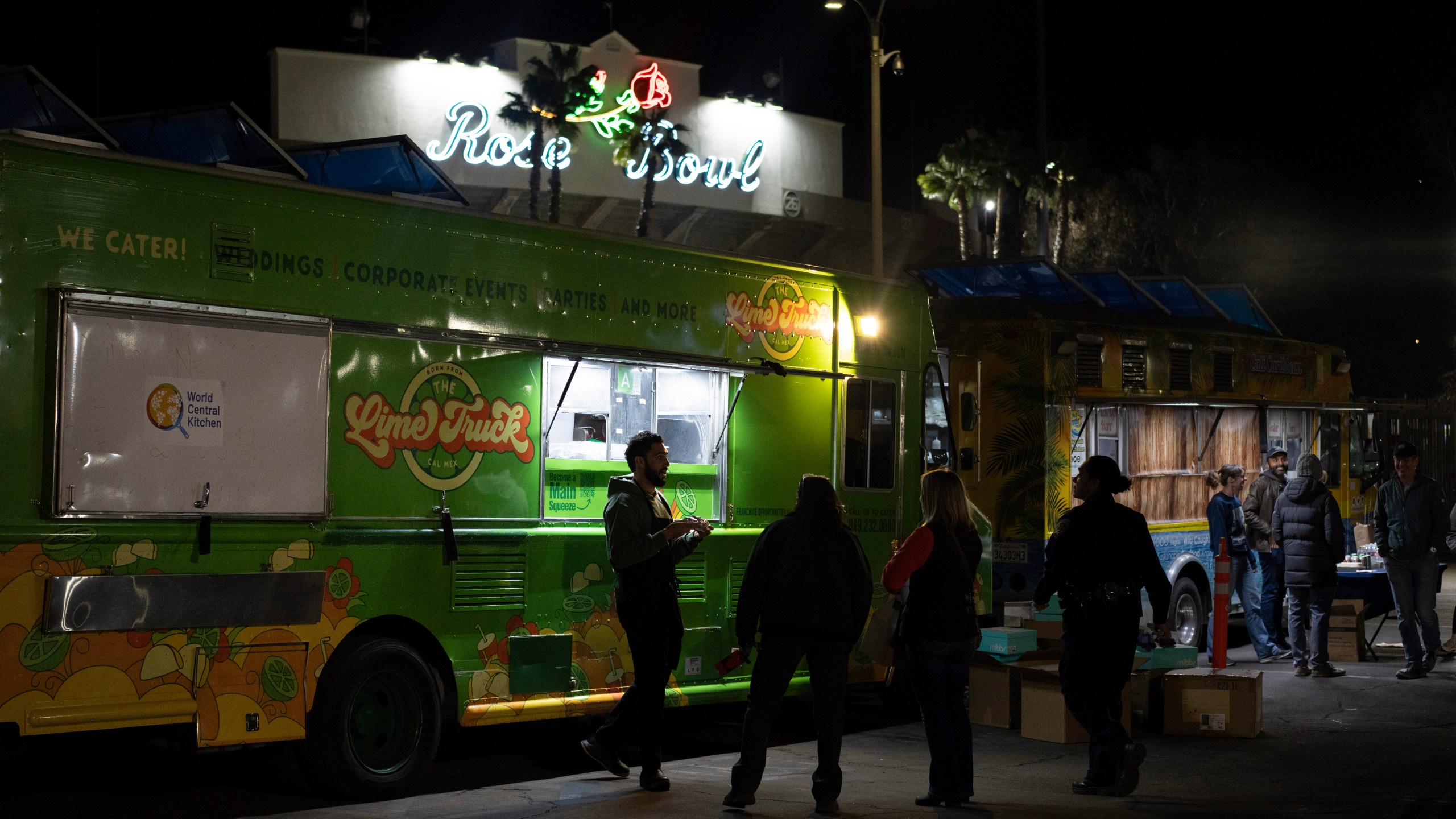 World Central Kitchen Chef Corp member Daniel Shemtob, left, serves Eaton Fire first responders from his food truck, The Lime Truck, at the Rose Bowl Stadium, Wednesday, Jan. 15, 2025, in Pasadena, Calif. (AP Photo/Carolyn Kaster)