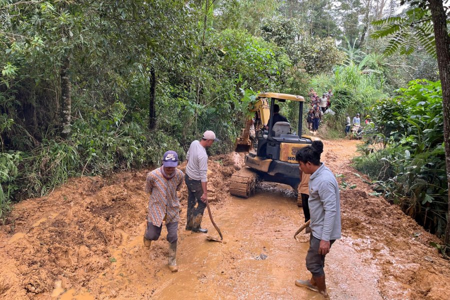 Workers clear a road cut off by a landslide following a flash flood in Pekalongan, Central Java, Indonesia, Wednesday, Jan. 22, 2025. (AP Photo/Janaki DM)