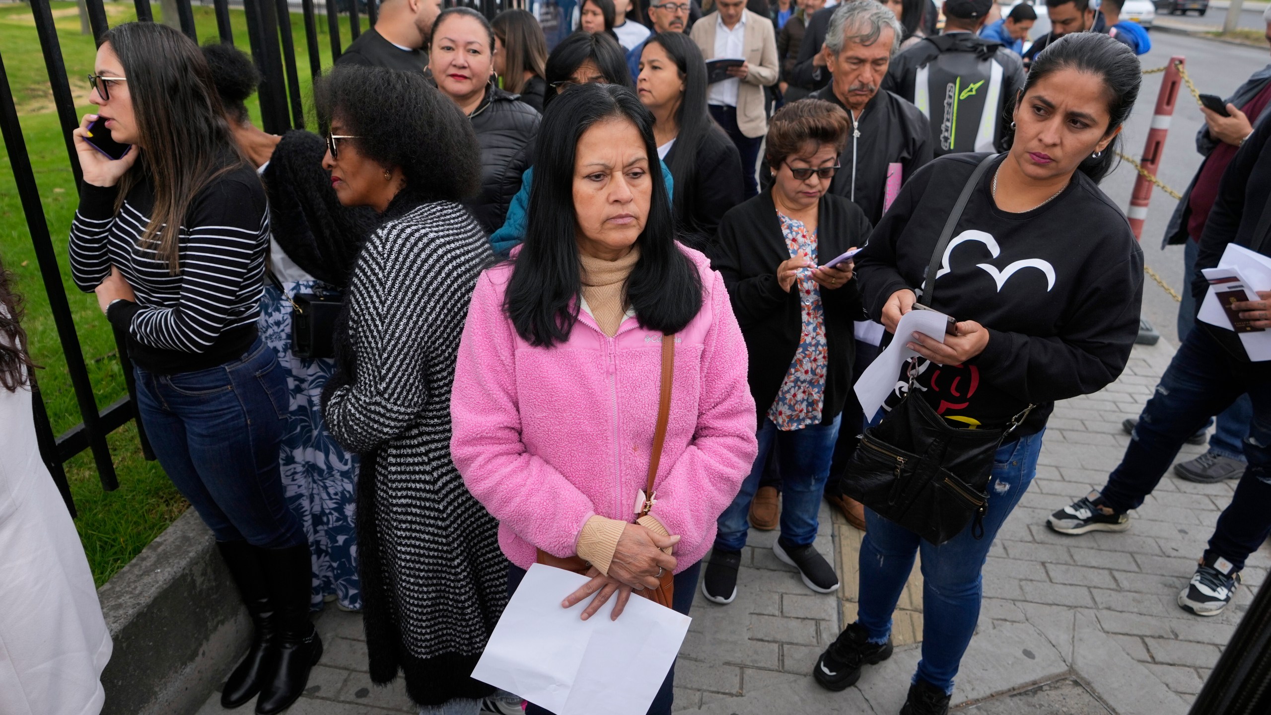 Gloria Camacho holds a notification stating her visa appointment was canceled, due to Colombian President Gustavo Petro's refusal to accept repatriation flights of Colombian citizens from the U.S., outside the U.S. embassy in Bogota, Colombia, Monday, Jan. 27, 2025. (AP Photo/Fernando Vergara)