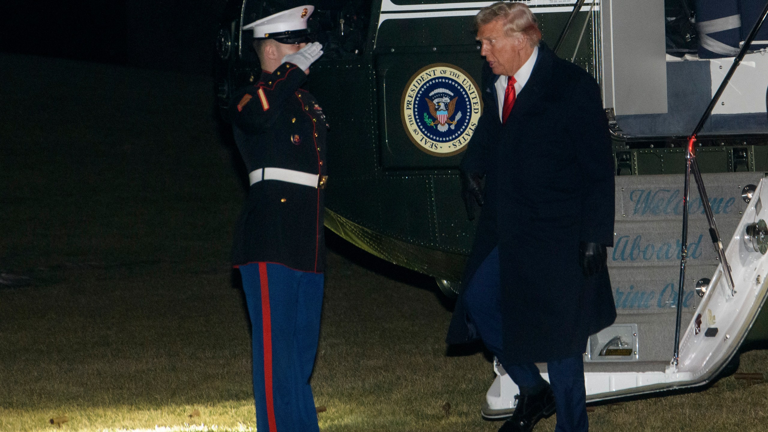 President Donald Trump greets a Marine Corps honor guard as he disembarks Marine One upon arrival on the South Lawn of the White House in Washington, Monday, Jan. 27, 2025. (AP Photo/Rod Lamkey, Jr.)