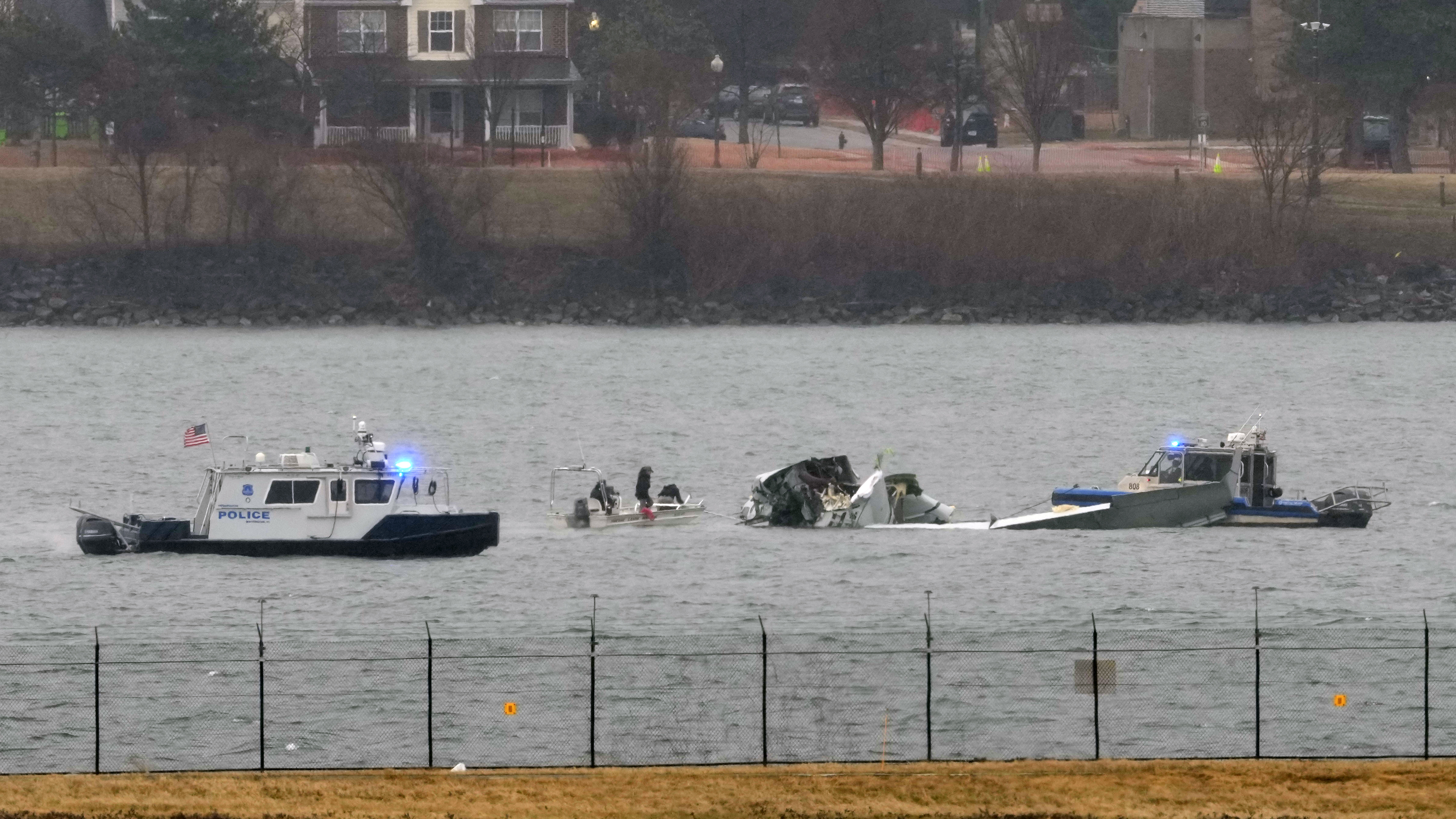 Search efforts are seen around a wreckage site of a deadly midair collision between an American Airlines jet and an Army helicopter, in the Potomac River near Ronald Reagan Washington National Airport, Friday, Jan. 31, 2025, in Arlington, Va. (AP Photo/Alex Brandon)