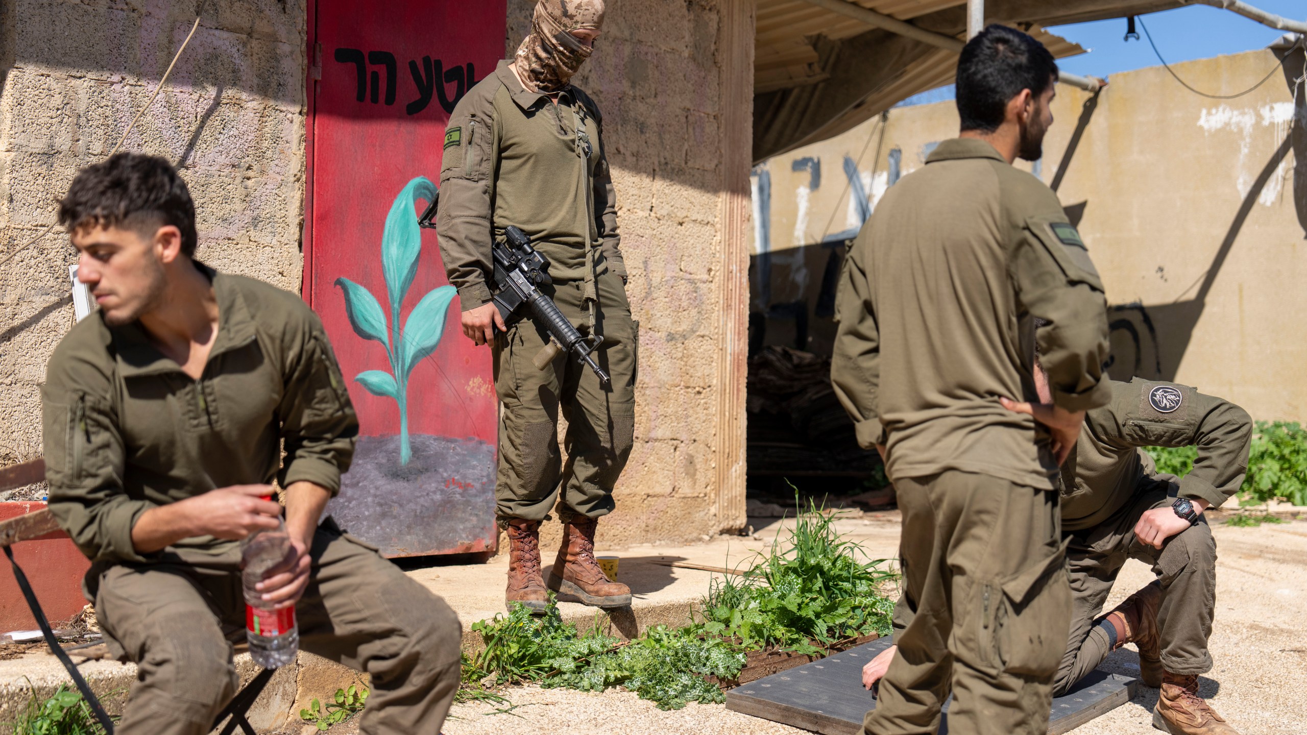 Israeli soldiers gather in northern Israel after Israeli forces withdrew from border villages in southern Lebanon ,Tuesday, Feb. 18, 2025. (AP Photo/Ariel Schalit)