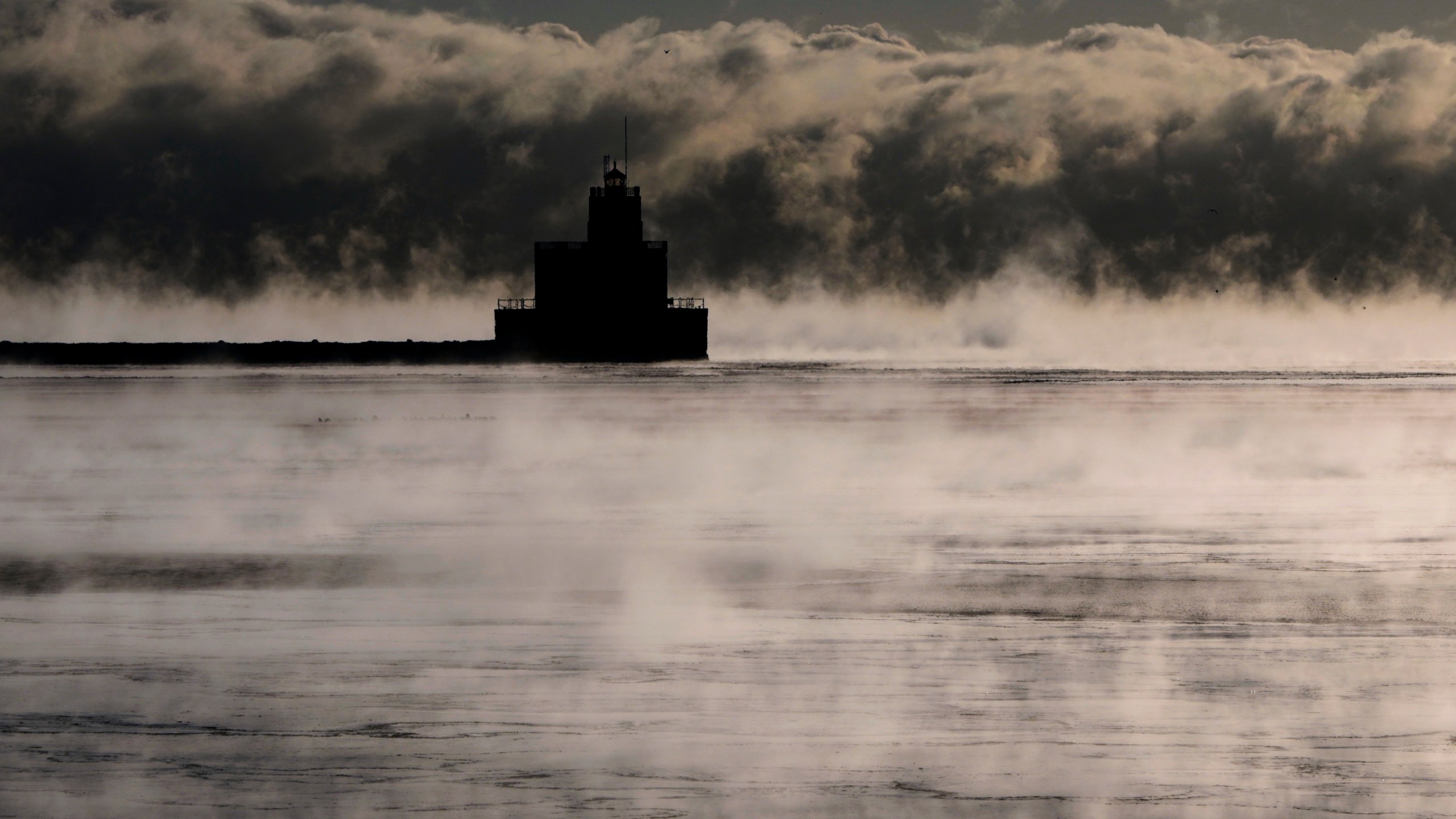 With temperatures below zero, steam rises over Lake Michigan Tuesday, Feb. 18, 2025, in Milwaukee. (AP Photo/Morry Gash)