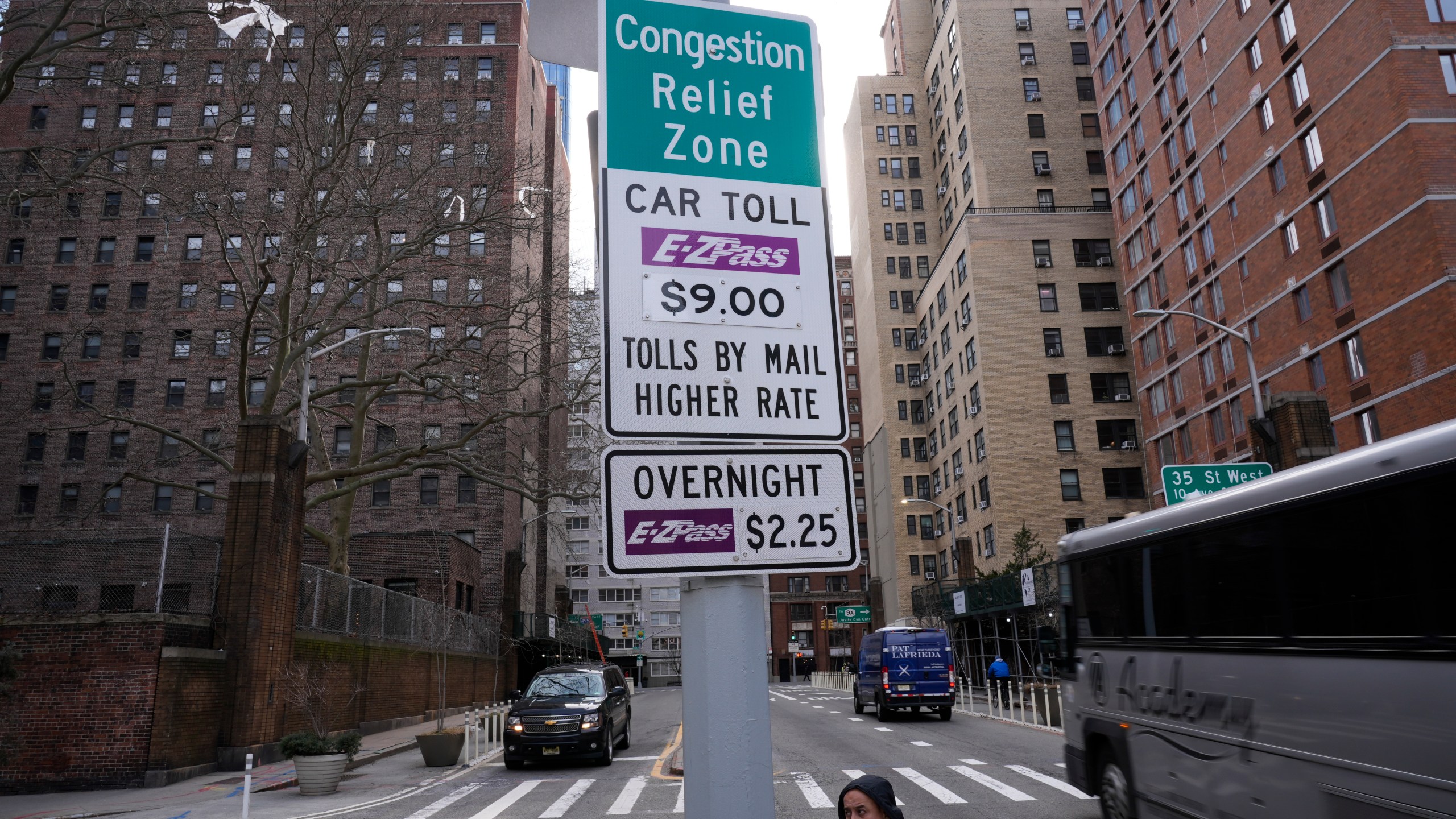 Signs advising drivers of congestion pricing tolls are displayed near the exit of the Lincoln Tunnel in New York, Wednesday, Feb. 19, 2025. (AP Photo/Seth Wenig)