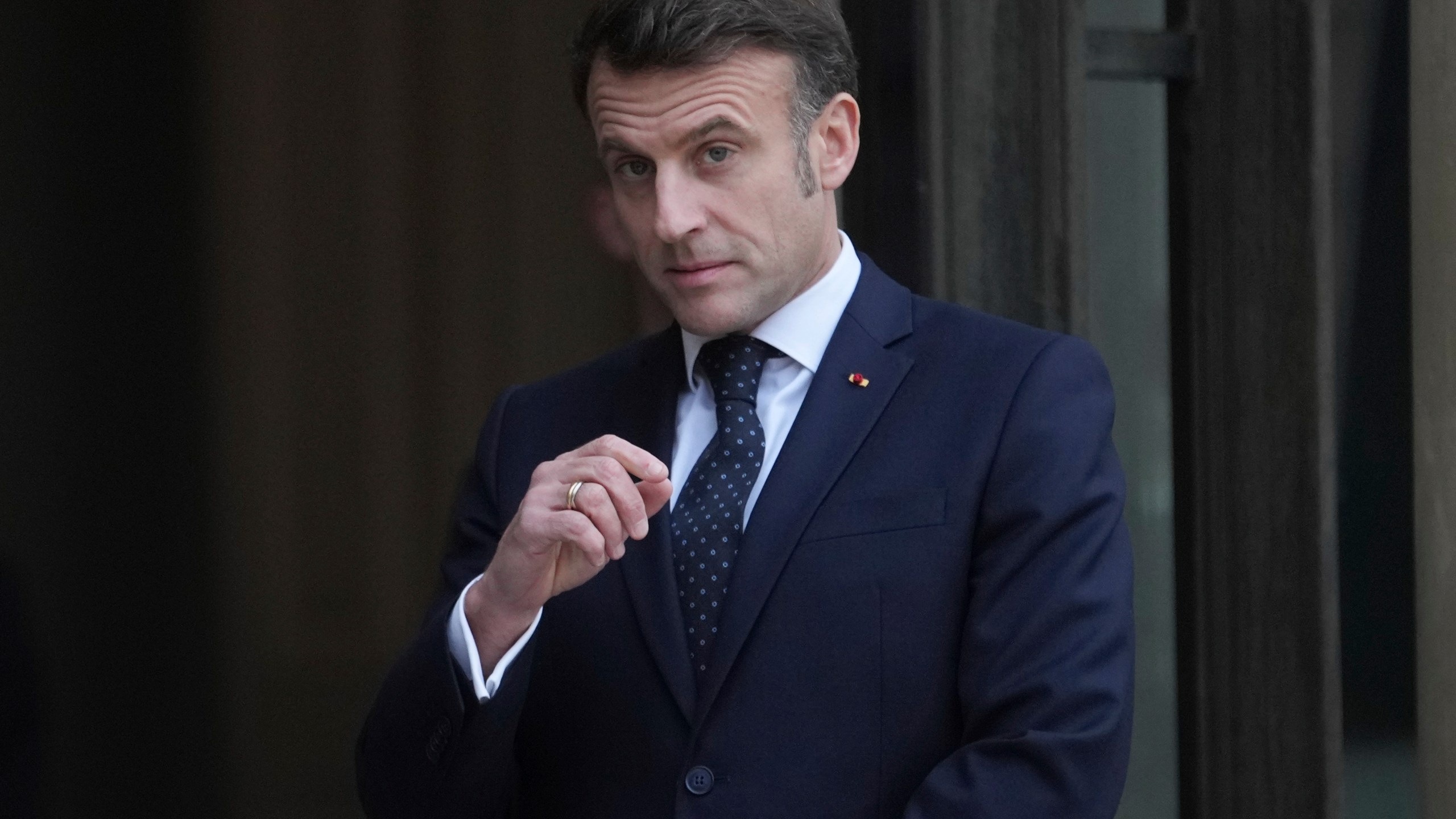 France's President Emmanuel Macron waits for Romania's Interim President Ilie Boloja, before a meeting on European security, Wednesday, Feb. 19, 2025, at the Elysee Palace in Paris. (AP Photo/Thibault Camus)