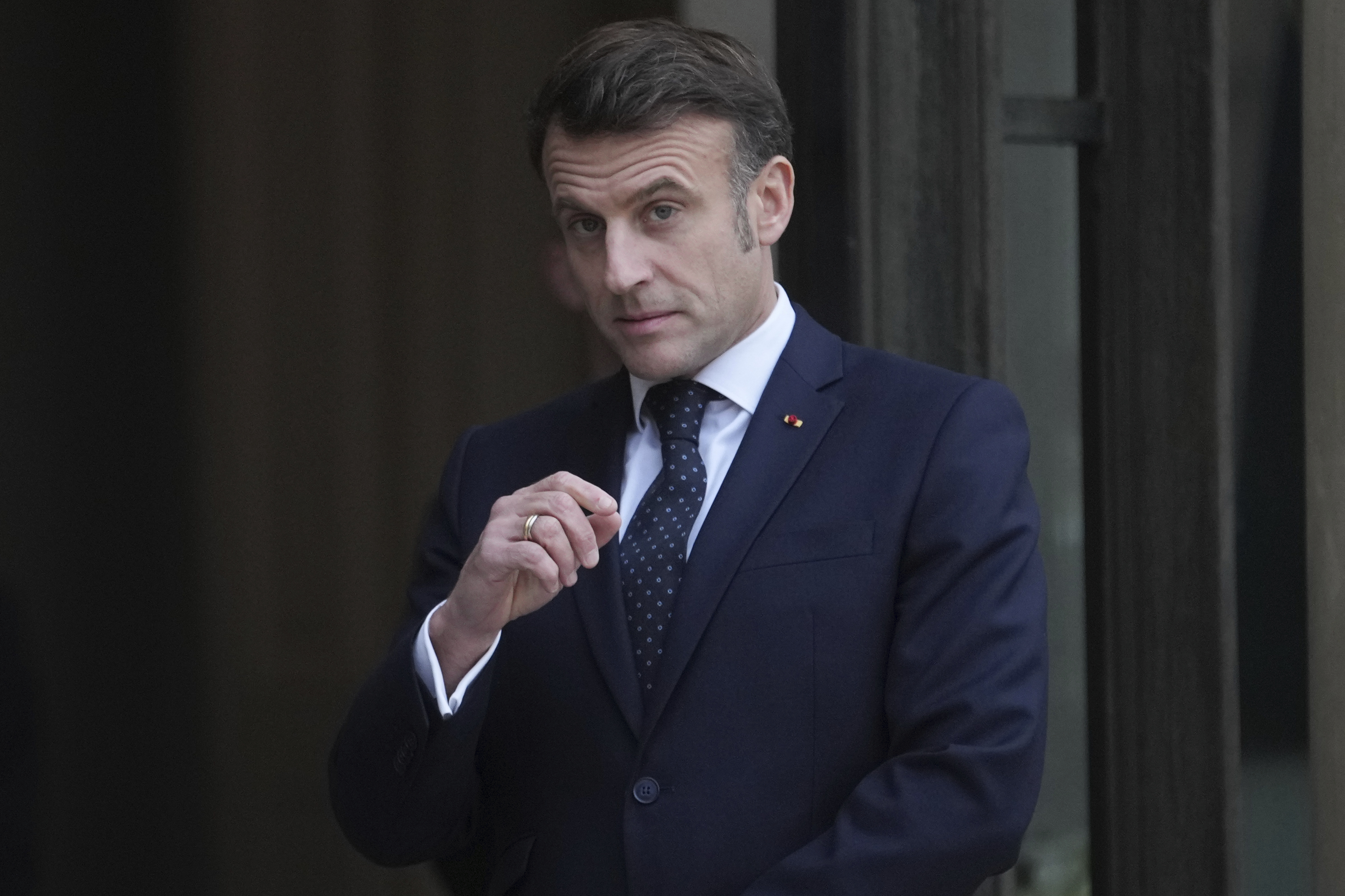 France's President Emmanuel Macron waits for Romania's Interim President Ilie Boloja, before a meeting on European security, Wednesday, Feb. 19, 2025, at the Elysee Palace in Paris. (AP Photo/Thibault Camus)