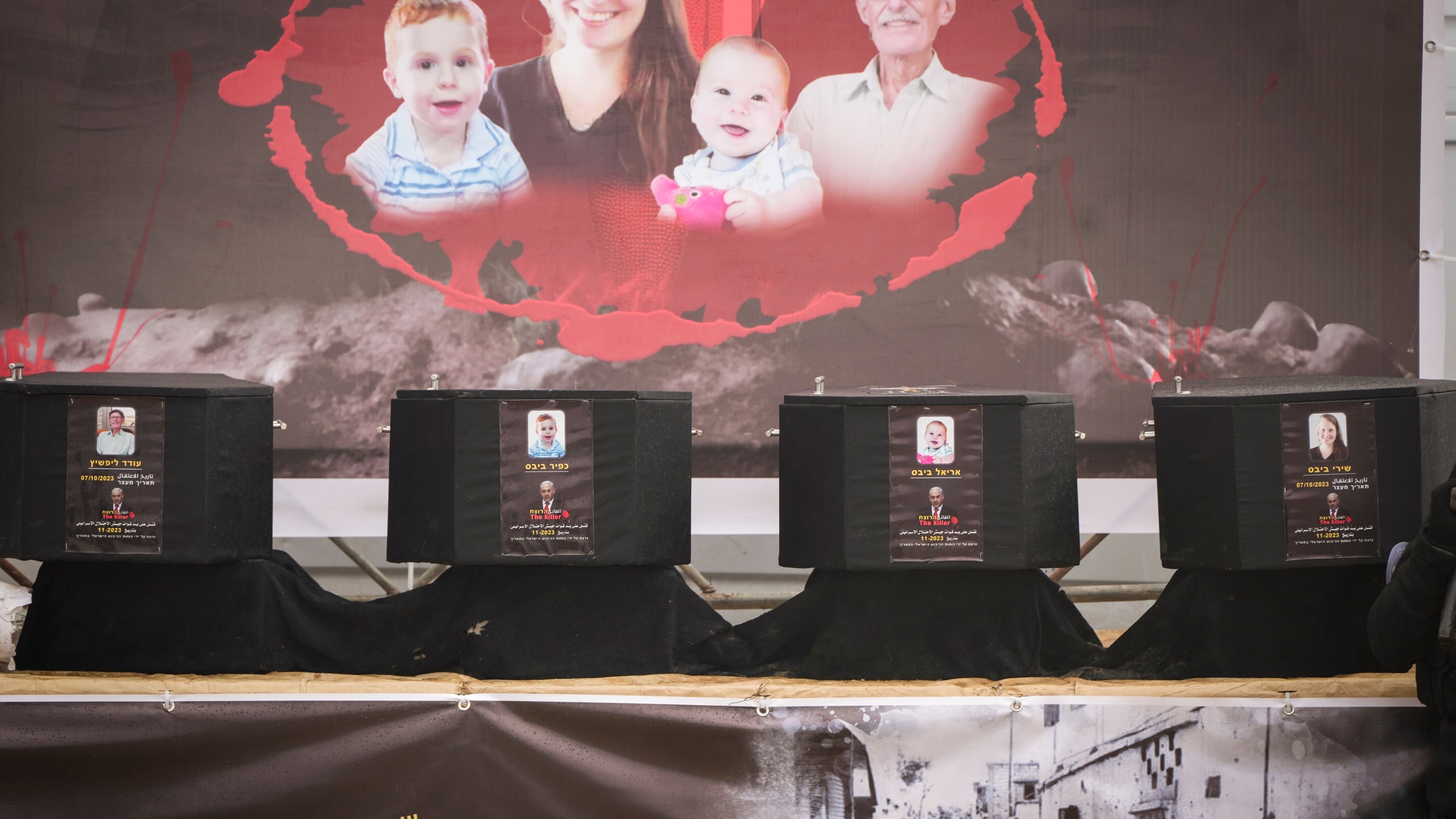 Coffins containing the bodies of four people are displayed on a stage in Khan Younis, southern Gaza Strip, before being handed over to the Red Cross by Hamas and Islamic Jihad, Thursday, Feb. 20, 2025. Israel has identified three of the bodies as hostages and said the other was of an unknown person. (AP Photo/Abdel Kareem Hana)