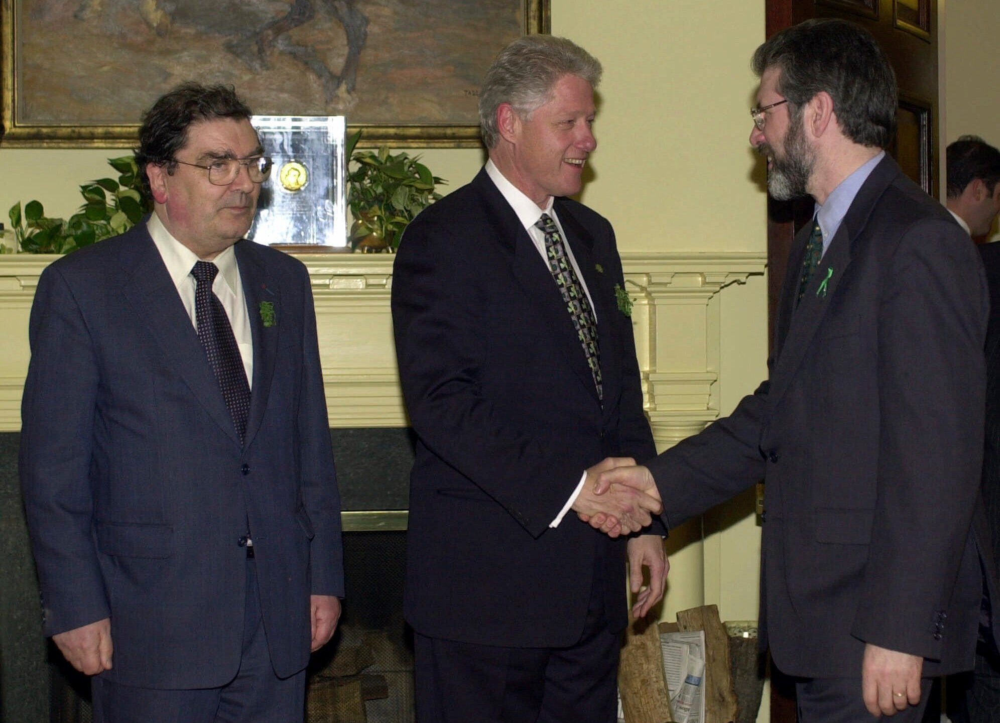 FILE - President Clinton greets Sinn Fein President Gerry Adams, right, as Social Democratic Labor Party leader John Hume stands at left, in the Roosevelt Room of the White House in Washington, Friday, March 17, 2000. (AP Photo/Susan Walsh, File)