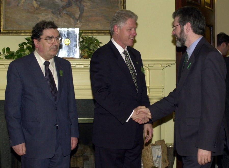 FILE - President Clinton greets Sinn Fein President Gerry Adams, right, as Social Democratic Labor Party leader John Hume stands at left, in the Roosevelt Room of the White House in Washington, Friday, March 17, 2000. (AP Photo/Susan Walsh, File)