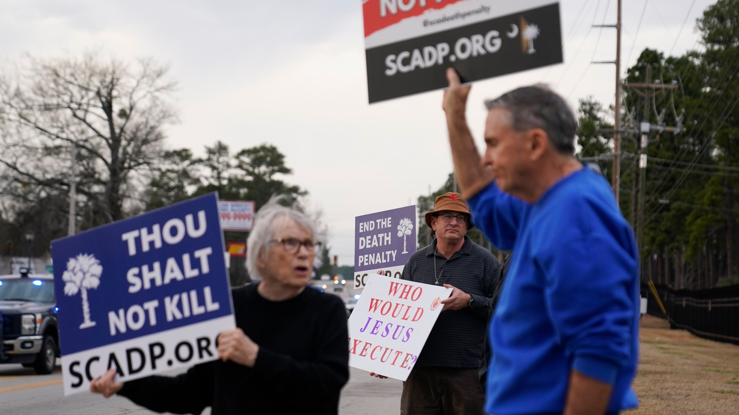 People protest prior to the scheduled execution of Marion Bowman Jr. outside of a South Carolina Department of Corrections facility, Friday, Jan. 31, 2025, in Columbia, S.C. (AP Photo/Erik Verduzco)