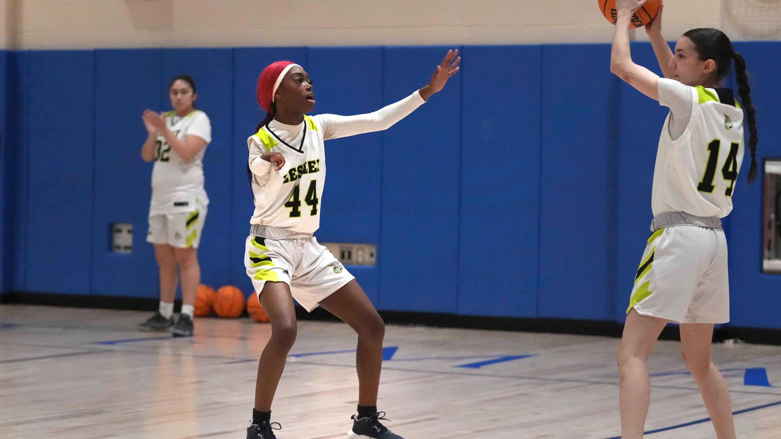 Lesley University basketball player Baileigh Sinaman-Daniel (44) pressures teammate Leila Chisholm while practicing prior to game, Tuesday, Feb. 11, 2025, in Lexington, Mass. (AP Photo/Charles Krupa)