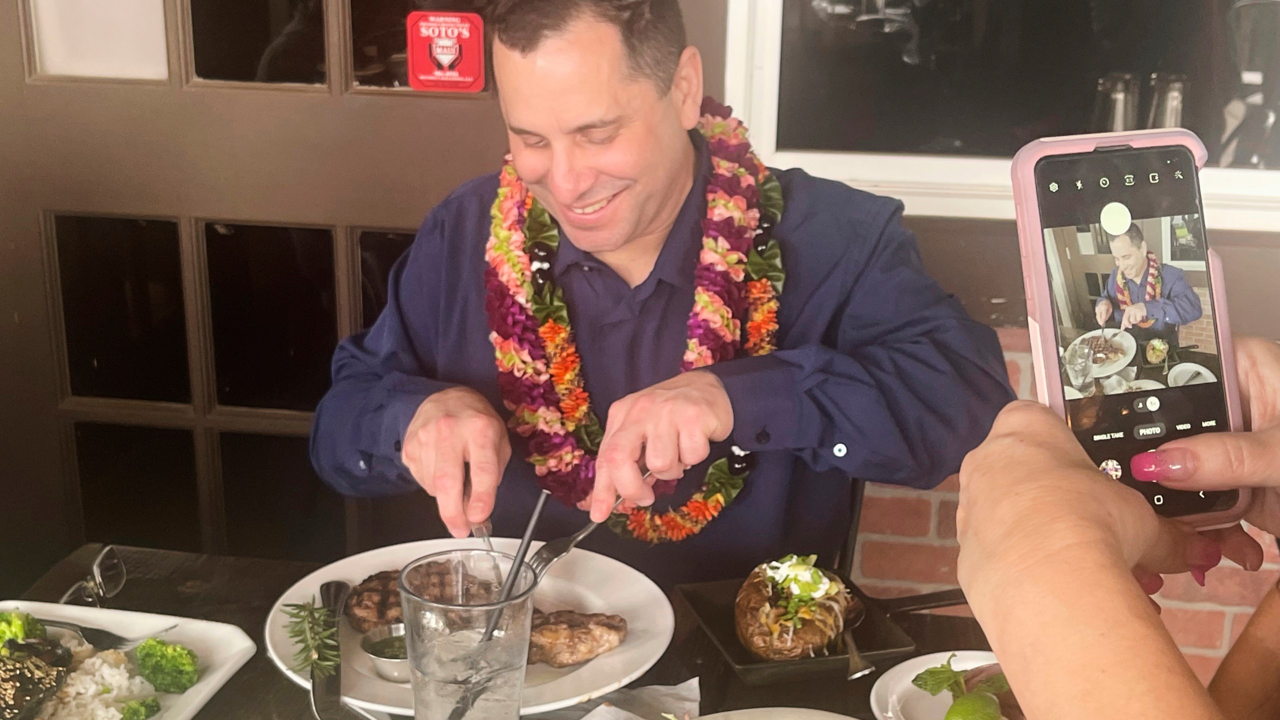 In this photo provided by Kenneth Lawson, Gordon Cordeiro, who spent 30 years in prison for a murder he said he didn't commit, enjoys dinner at a steak house Friday, Feb. 21, 2025, in Kahului, Hawaii, hours after a judge ordered him released because of new evidence. (Kenneth Lawson via AP)