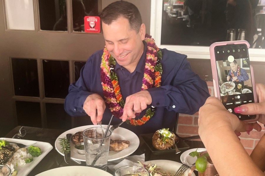 In this photo provided by Kenneth Lawson, Gordon Cordeiro, who spent 30 years in prison for a murder he said he didn't commit, enjoys dinner at a steak house Friday, Feb. 21, 2025, in Kahului, Hawaii, hours after a judge ordered him released because of new evidence. (Kenneth Lawson via AP)