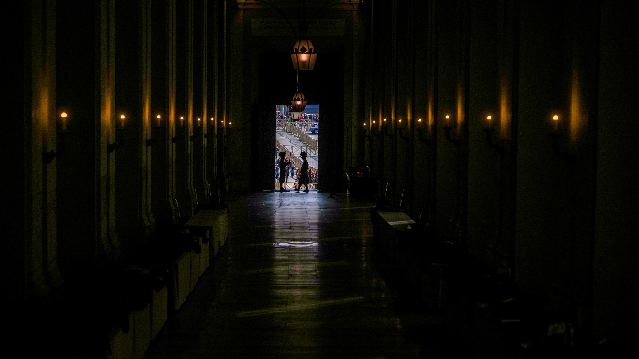 Vatican Swiss guards surveil the Bronze Door, the main entrance to the papal apartments, at The Vatican, Sunday, Feb. 23, 2025, as Pope Francis who was admitted over a week ago at Rome's Agostino Gemelli Polyclinic is in critical conditions. (AP Photo/Alessandra Tarantino)