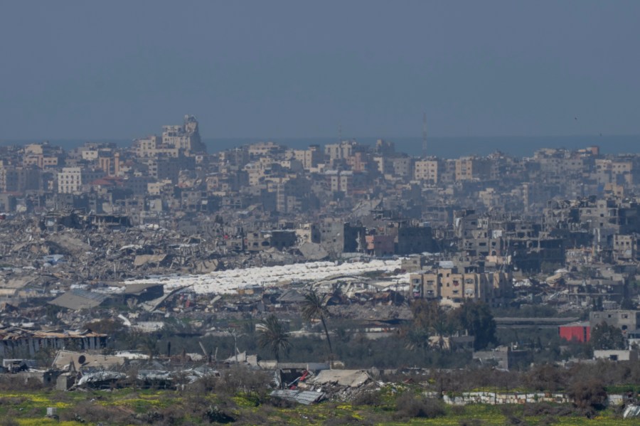 Tents are seen among the destroyed buildings in the Gaza Strip as seen from southern Israel, Tuesday, Feb. 25, 2025. (AP Photo/Ohad Zwigenberg)