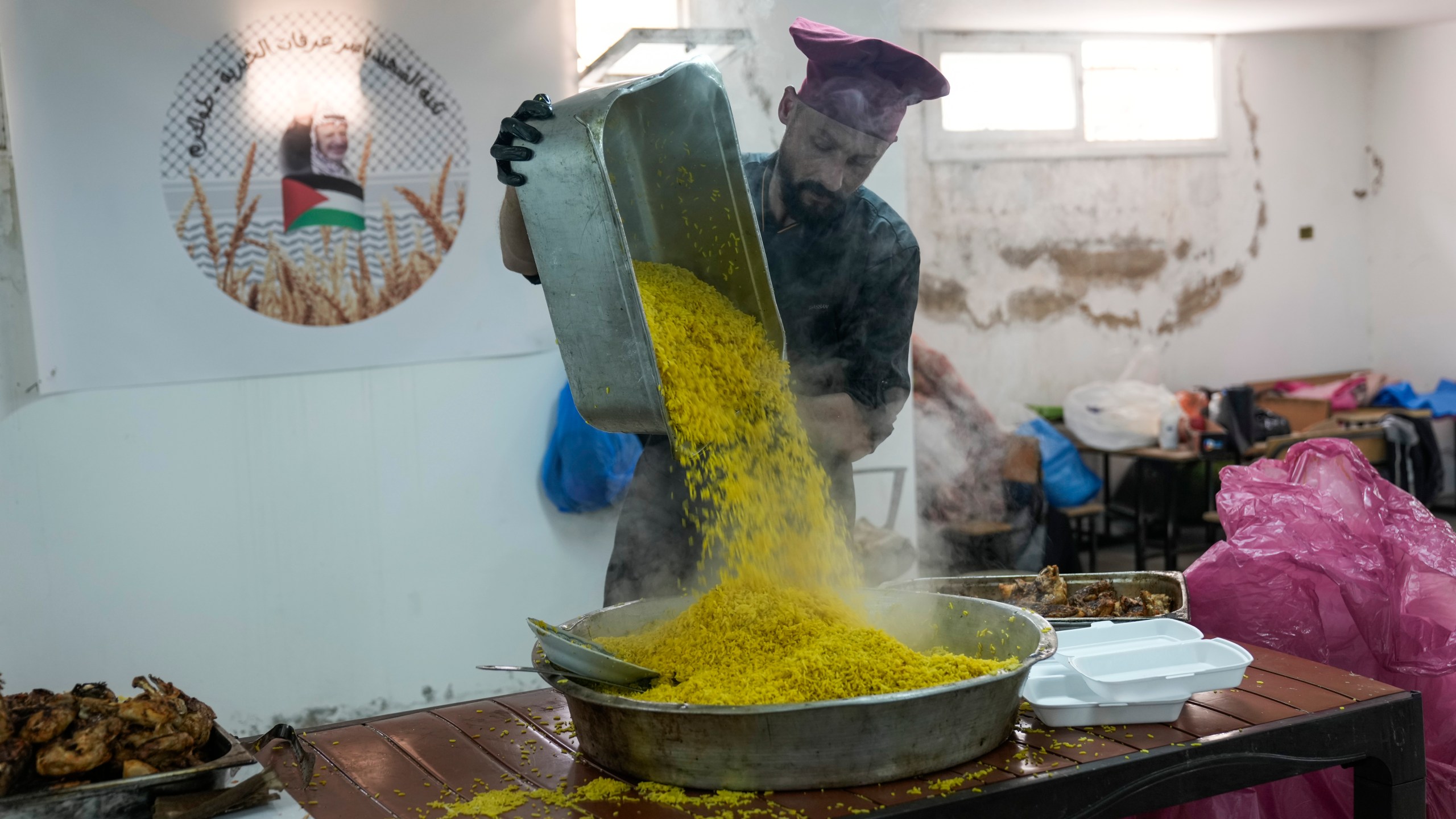 Volunteers at the Yasser Arafat Charity Kitchen in Tulkarem, West Bank, prepare an iftar meal for displaced Palestinians trying to mark the Muslim holy month of Ramadan on Monday, March 3, 2025. (AP Photo/Majdi Mohammed)