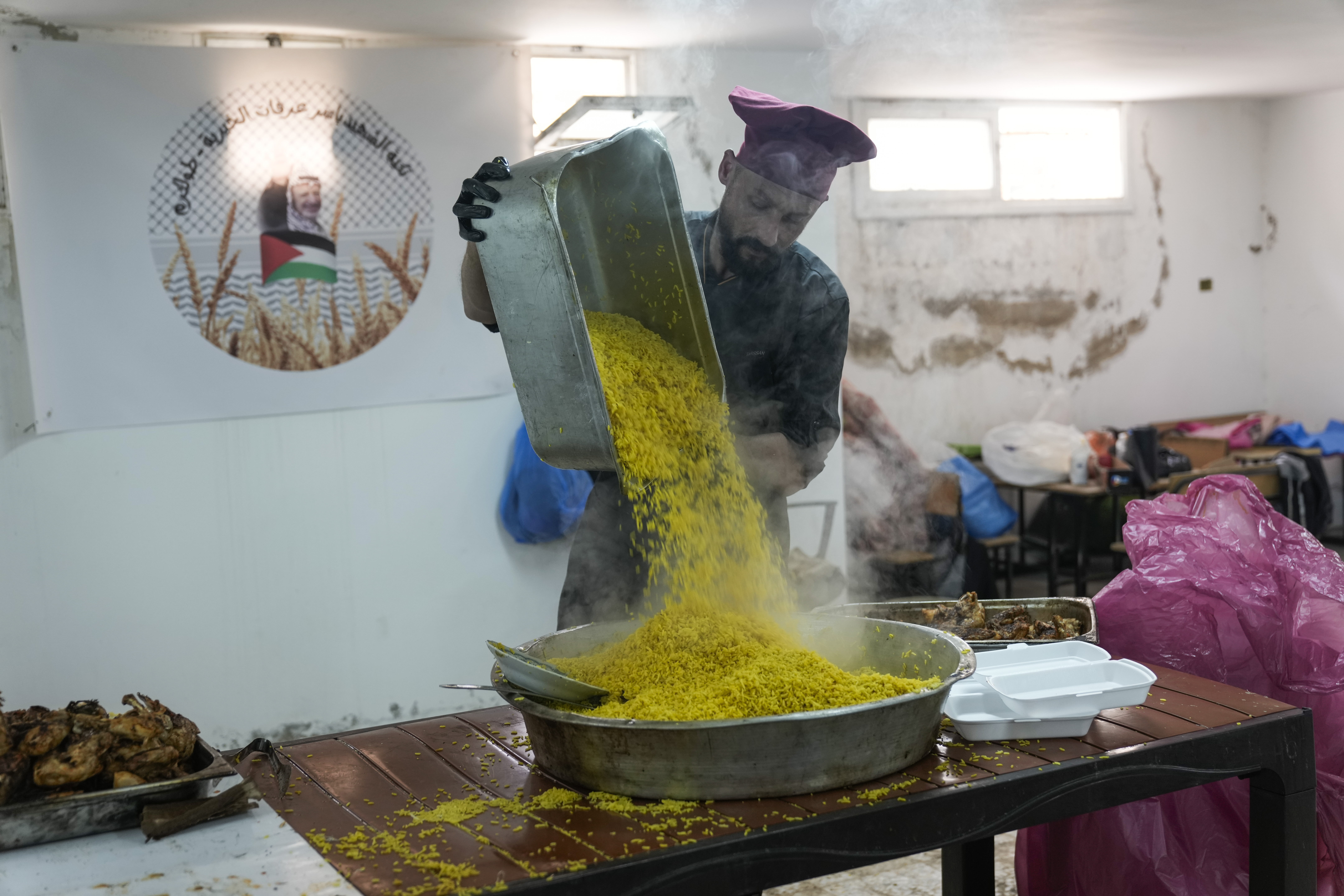 Volunteers at the Yasser Arafat Charity Kitchen in Tulkarem, West Bank, prepare an iftar meal for displaced Palestinians trying to mark the Muslim holy month of Ramadan on Monday, March 3, 2025. (AP Photo/Majdi Mohammed)