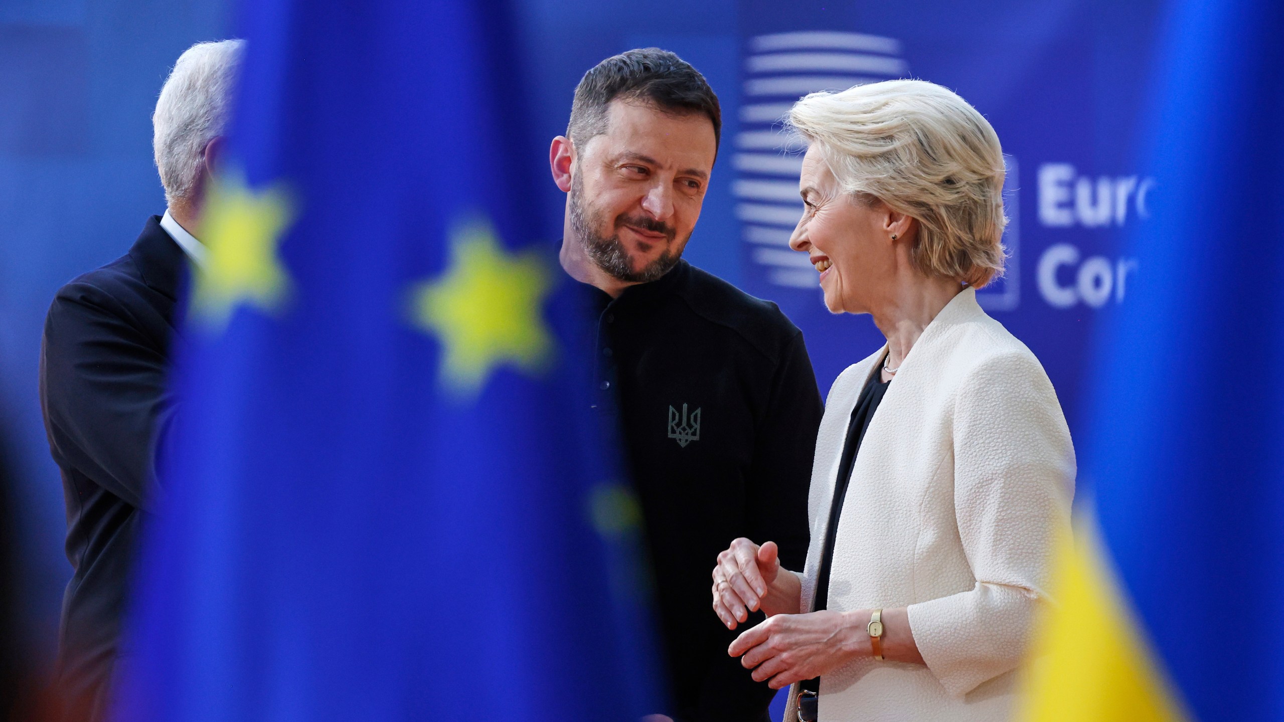 European Commission President Ursula von der Leyen, right, speaks with Ukraine's President Volodymyr Zelenskyy, center, as they arrive for an EU Summit at the European Council building in Brussels, Thursday, March 6, 2025. (AP Photo/Omar Havana)