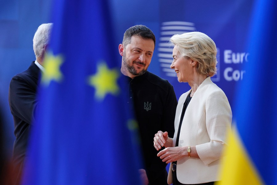 European Commission President Ursula von der Leyen, right, speaks with Ukraine's President Volodymyr Zelenskyy, center, as they arrive for an EU Summit at the European Council building in Brussels, Thursday, March 6, 2025. (AP Photo/Omar Havana)