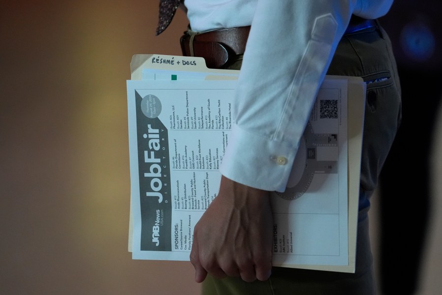 FILE - A person waits in a line for a prospective employer at a job fair, Thursday, Aug. 29, 2024, in Sunrise, Fla. (AP Photo/Lynne Sladky, File)