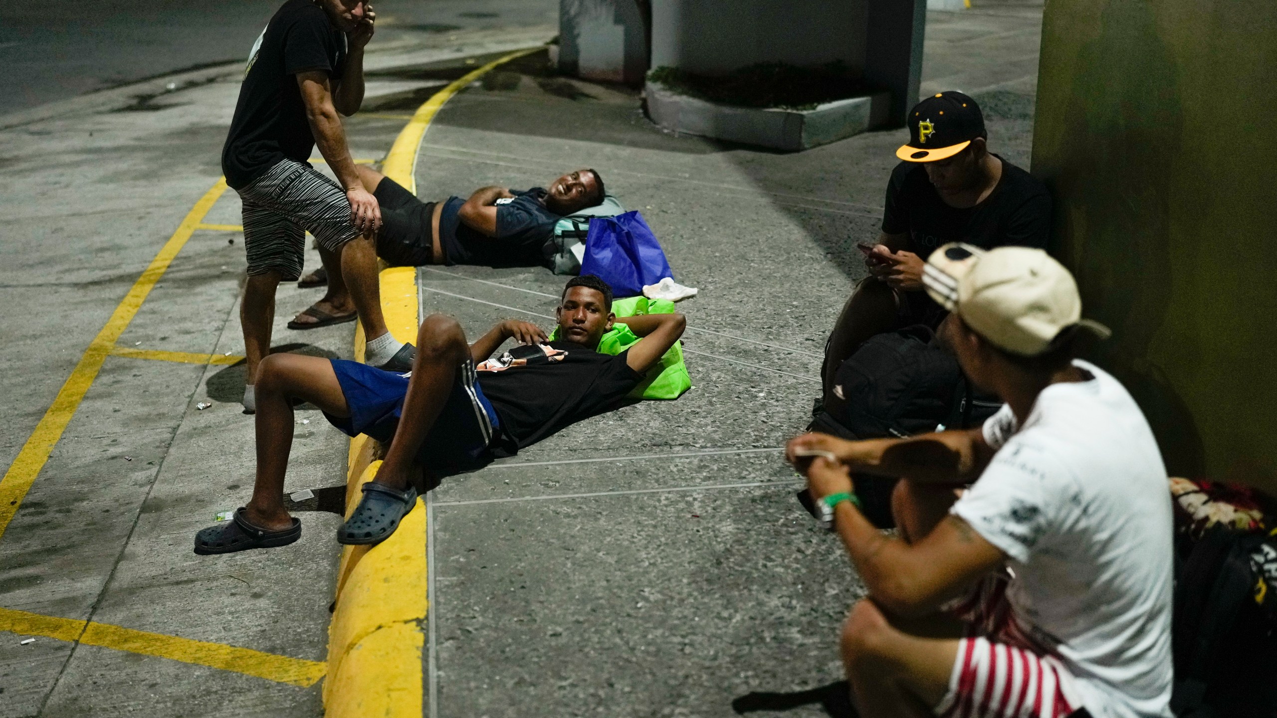 Venezuelan migrants returning from southern Mexico after giving up on reaching the U.S. rest on the street in Panama City, Thursday, March 6, 2025. (AP Photo/Matias Delacroix)