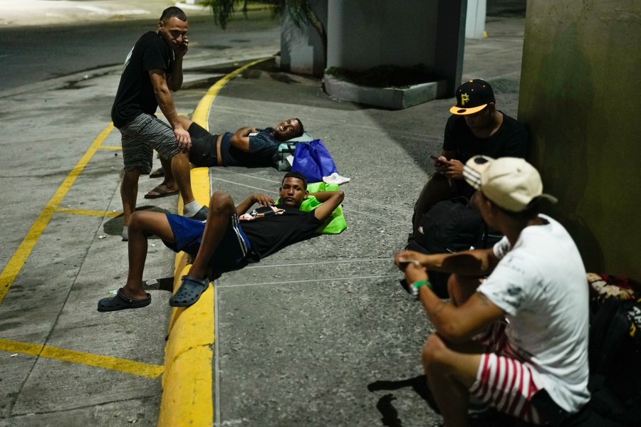 Venezuelan migrants returning from southern Mexico after giving up on reaching the U.S. rest on the street in Panama City, Thursday, March 6, 2025. (AP Photo/Matias Delacroix)