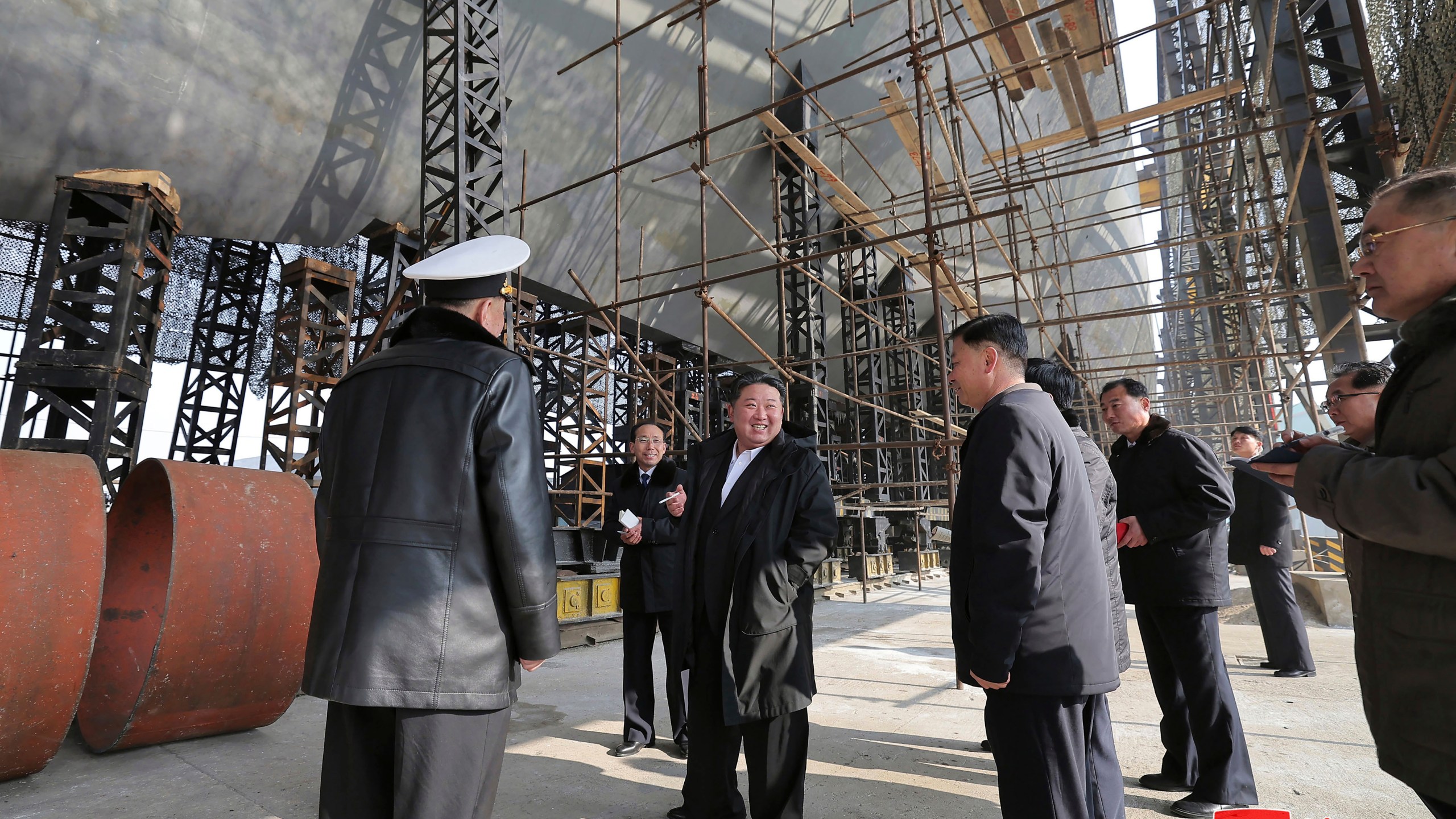 In this undated photo provided on March 8, 2025, by the North Korean government, North Korean leader Kim Jong Un, center, visits a shipyard to construct warships at an undisclosed place in North Korea. Independent journalists were not given access to cover the event depicted in this image distributed by the North Korean government. The content of this image is as provided and cannot be independently verified. Korean language watermark on image as provided by source reads: "KCNA" which is the abbreviation for Korean Central News Agency. (Korean Central News Agency/Korea News Service via AP)