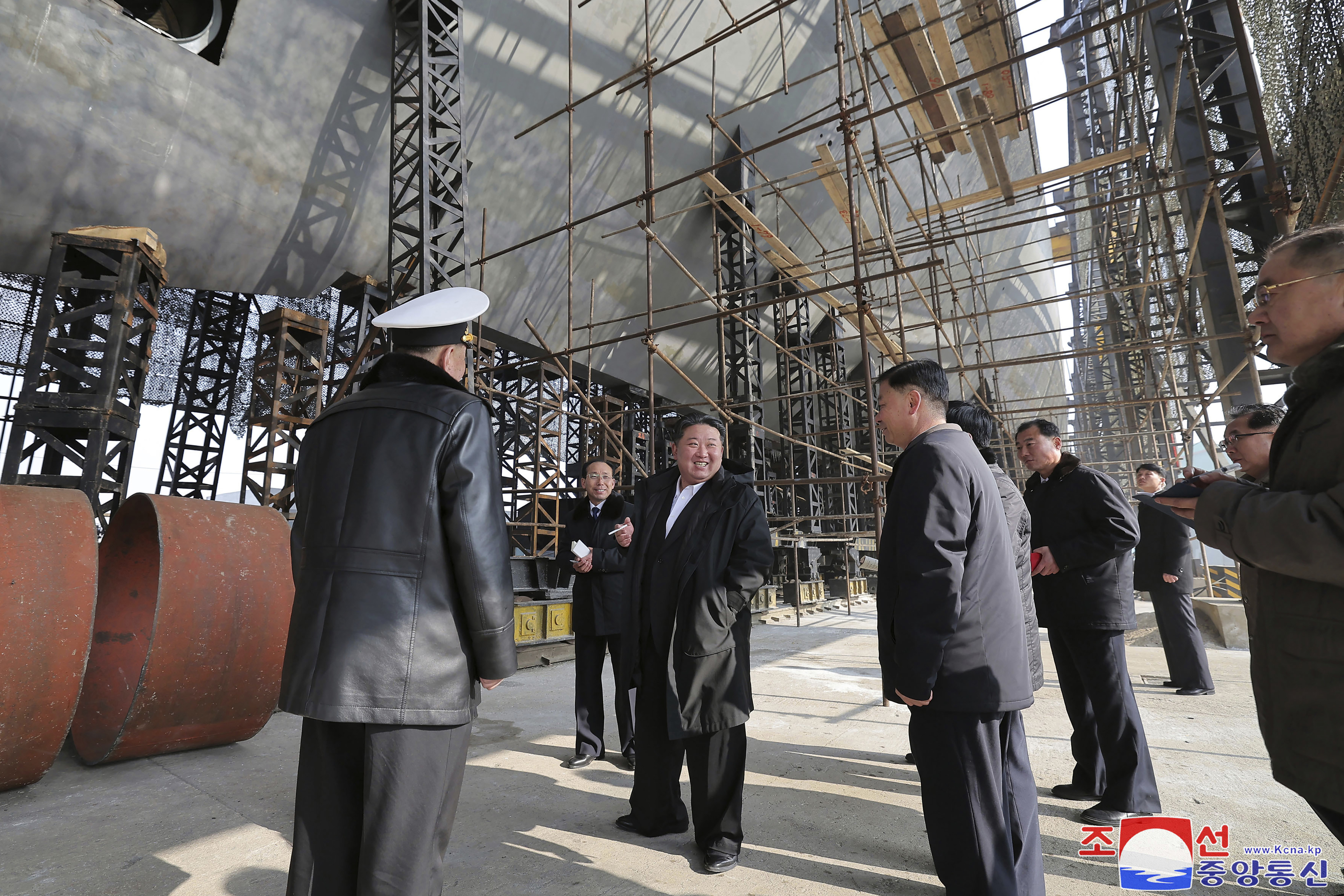 In this undated photo provided on March 8, 2025, by the North Korean government, North Korean leader Kim Jong Un, center, visits a shipyard to construct warships at an undisclosed place in North Korea. Independent journalists were not given access to cover the event depicted in this image distributed by the North Korean government. The content of this image is as provided and cannot be independently verified. Korean language watermark on image as provided by source reads: "KCNA" which is the abbreviation for Korean Central News Agency. (Korean Central News Agency/Korea News Service via AP)