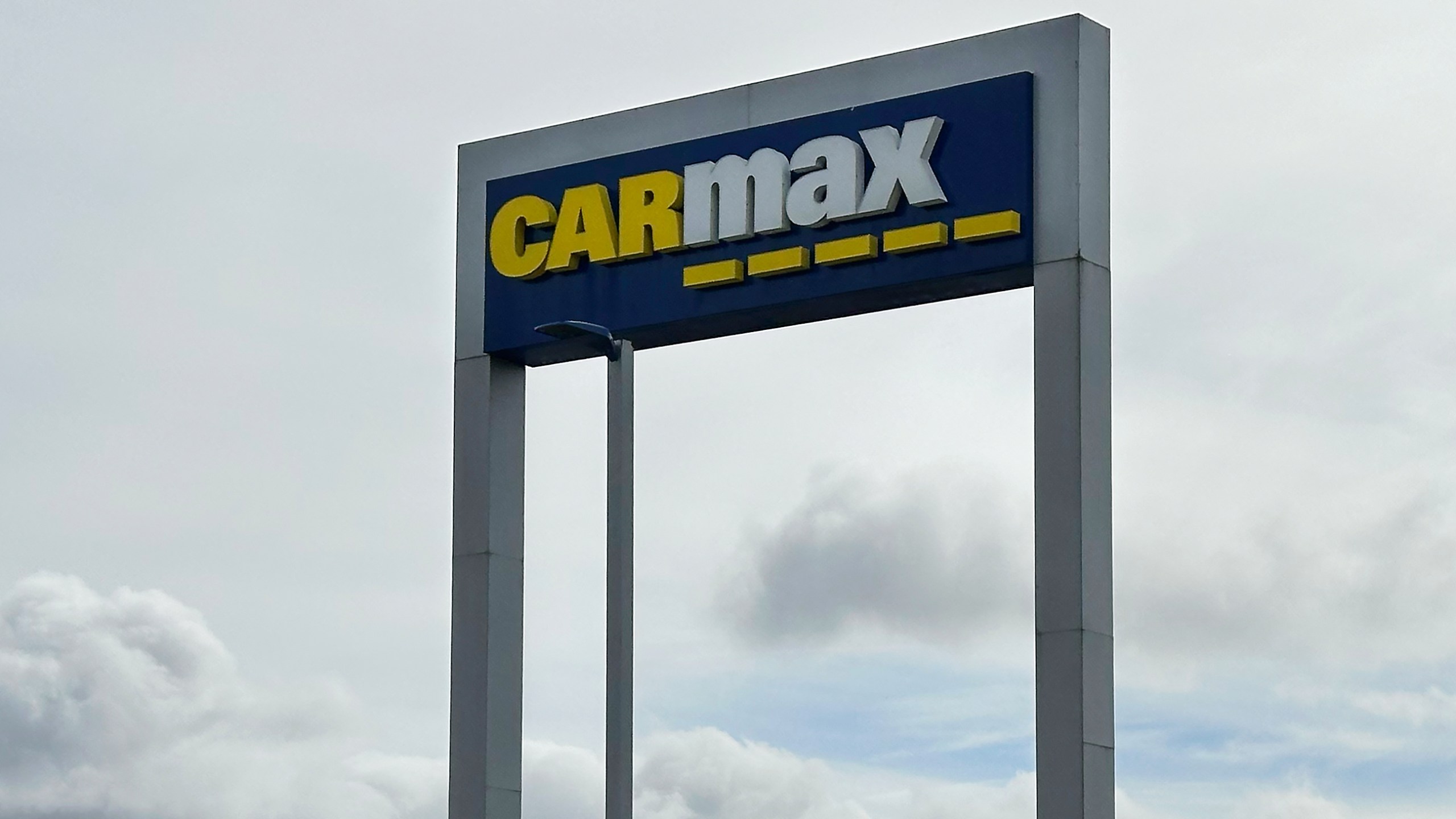 FILE - A CarMax sign stands at a location in Colma, Calif., March 4, 2024. (AP Photo/Jeff Chiu, File)